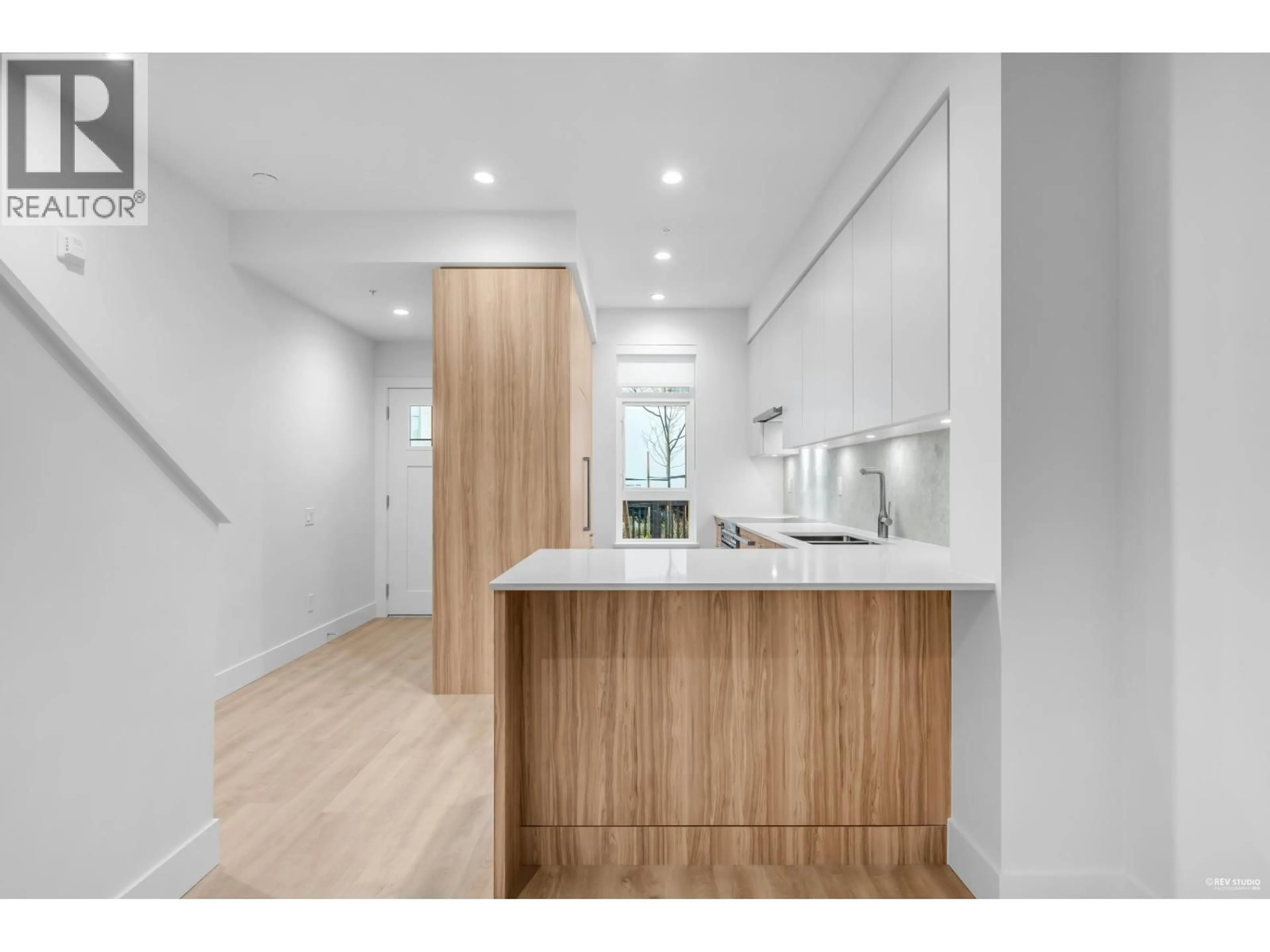 Open concept kitchen, wood/laminate floor for 105 - 2320 EMERY COURT, North Vancouver British Columbia V7J0G3