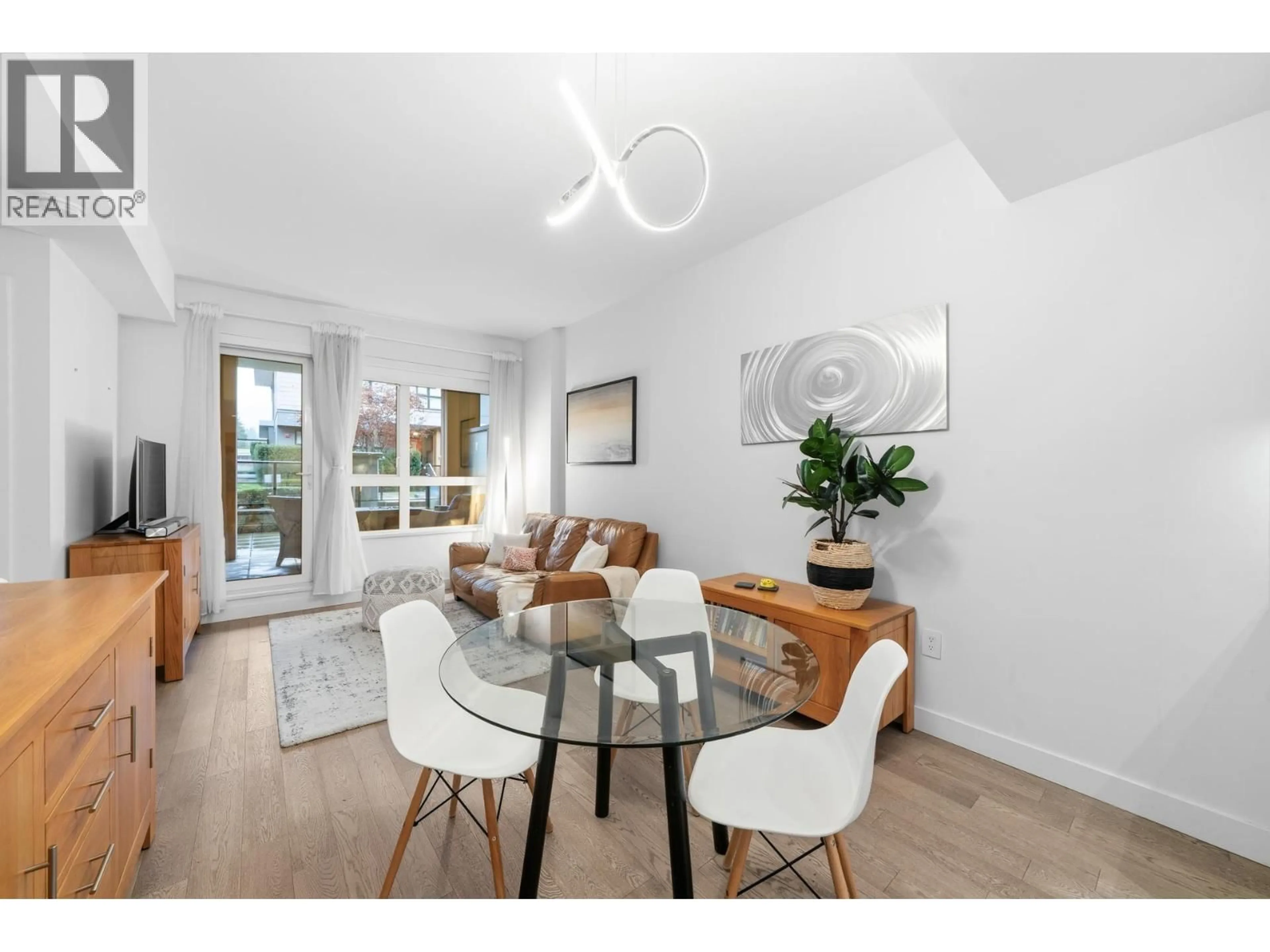 Living room with furniture, wood/laminate floor for 201 - 3220 CONNAUGHT CRESCENT, North Vancouver British Columbia V7R0A5