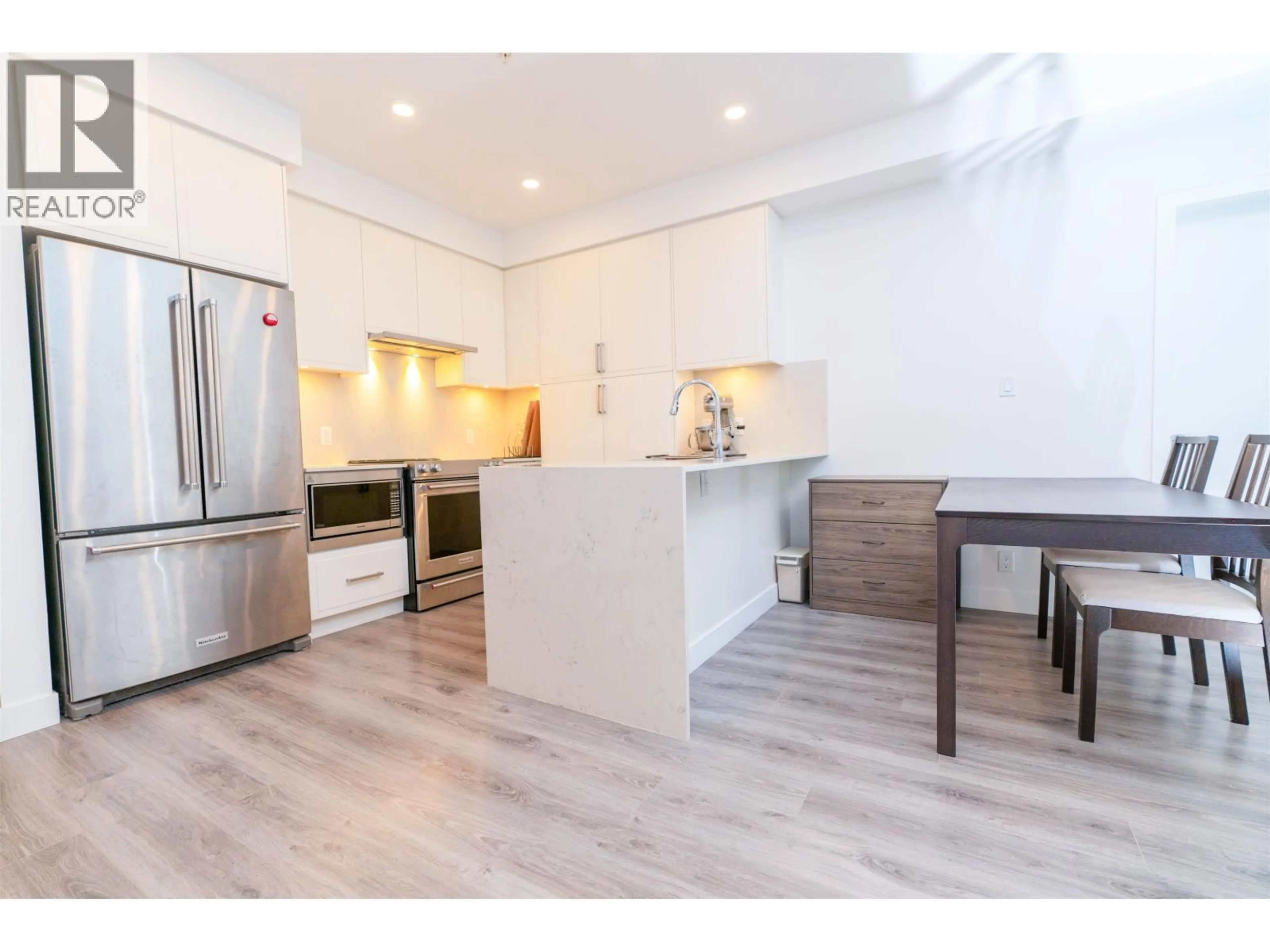 Open concept kitchen, wood/laminate floor for 505 - 700 CLARKE ROAD, Coquitlam British Columbia V3J0K5