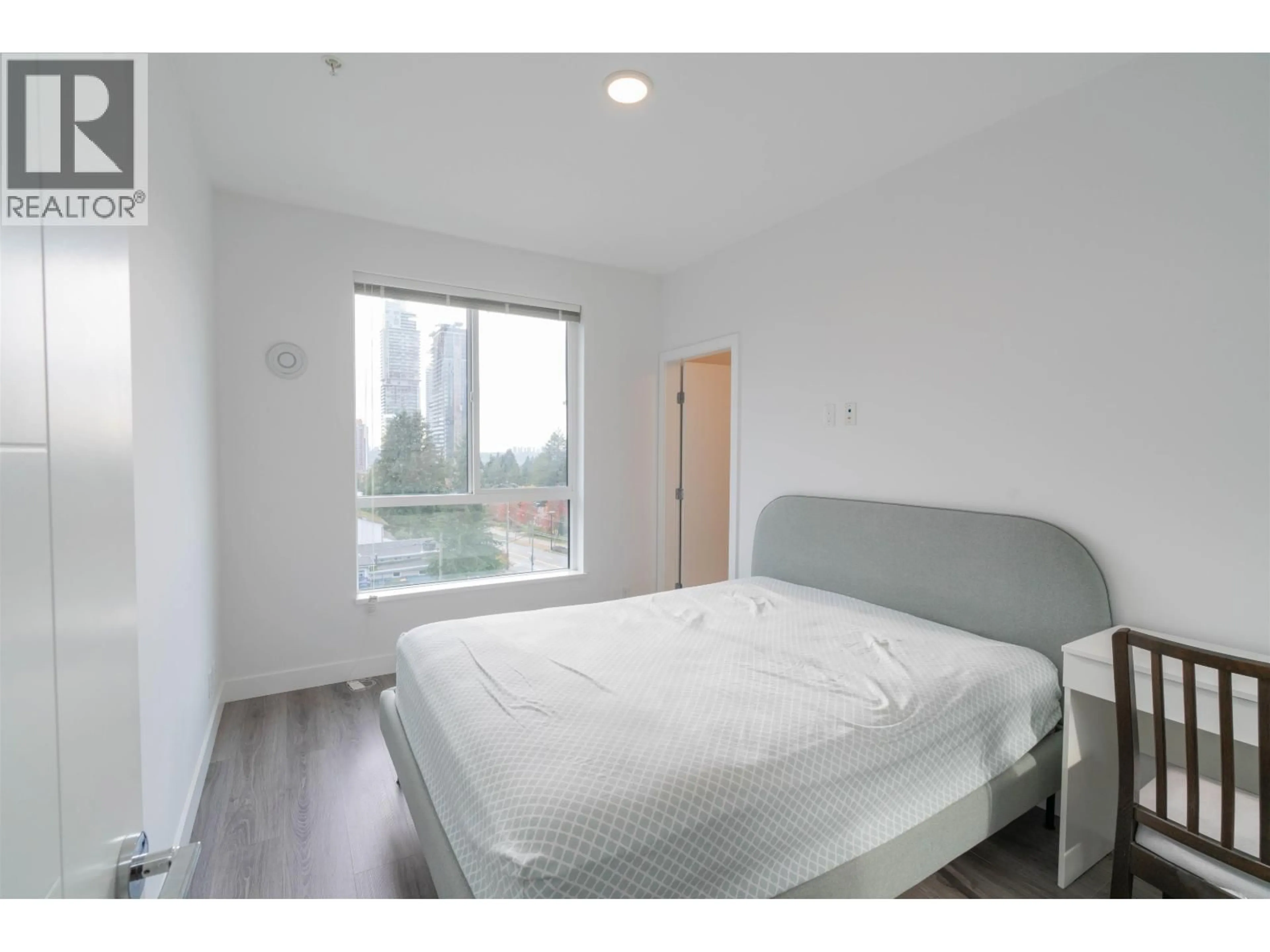 Bedroom with bed, wood/laminate floor for 505 - 700 CLARKE ROAD, Coquitlam British Columbia V3J0K5