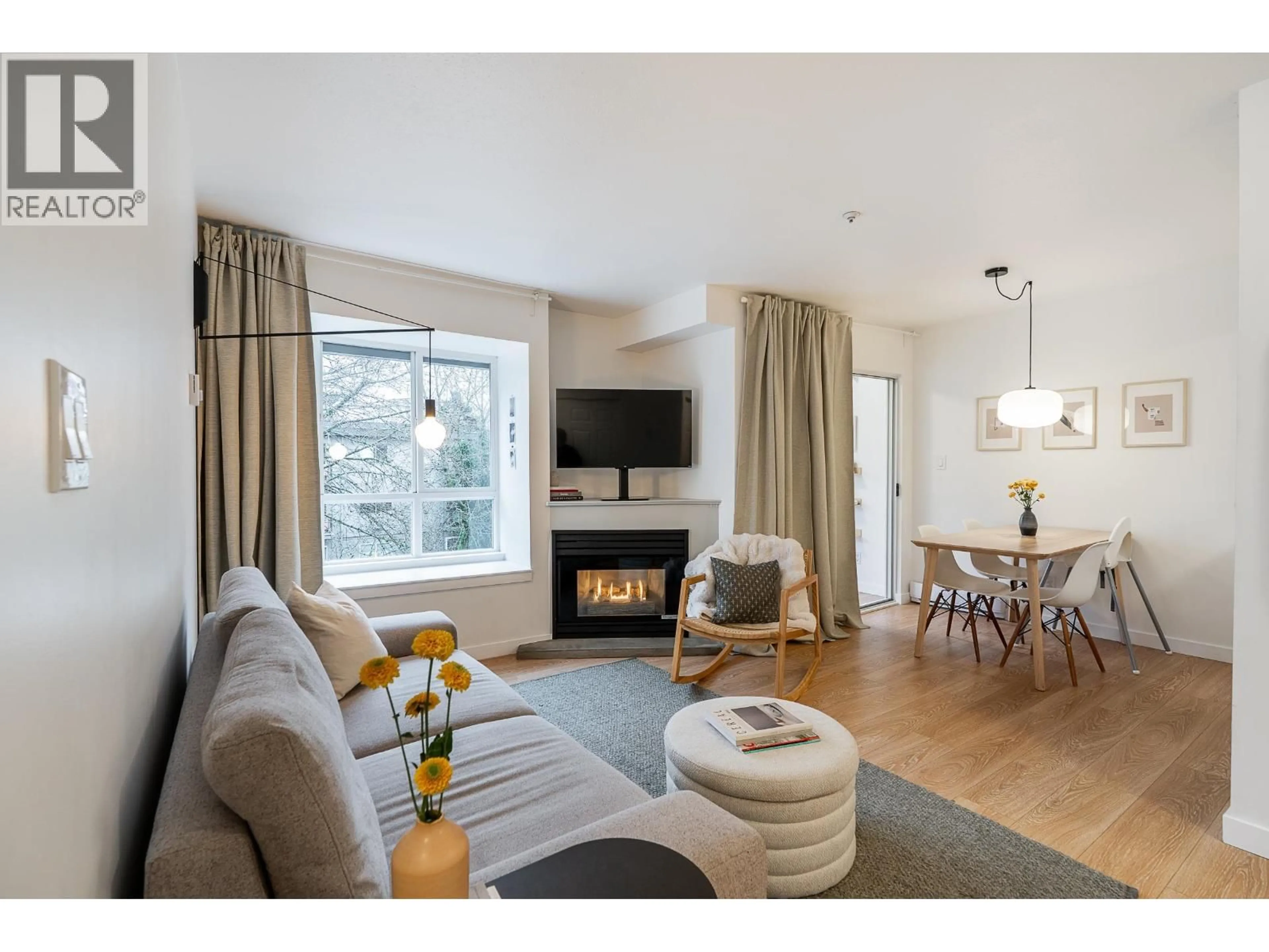 Living room with furniture, wood/laminate floor for 407 - 3 GARDEN DRIVE, Vancouver British Columbia V5L5C6