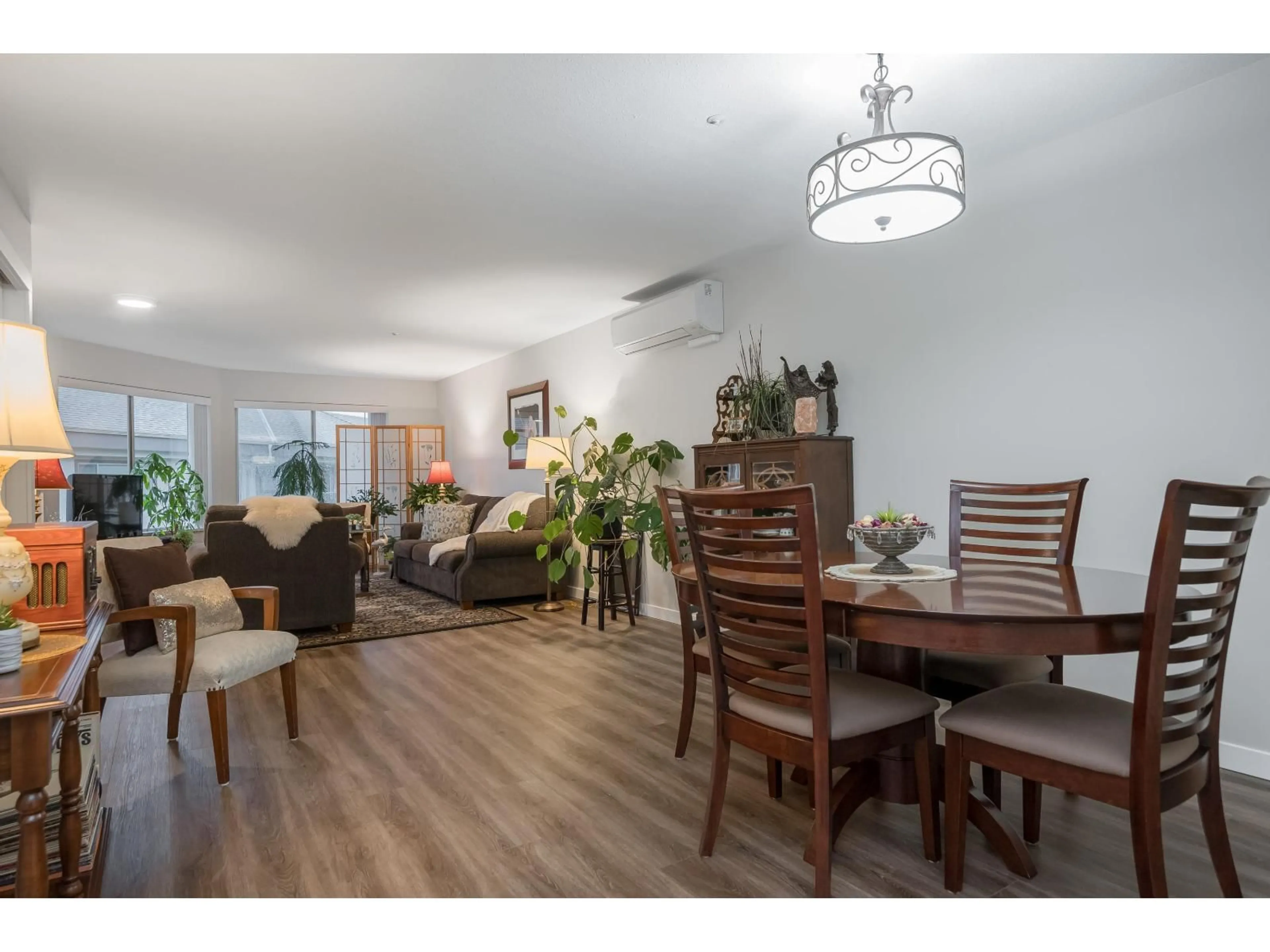 Living room with furniture, wood/laminate floor for 335 - 2451 GLADWIN ROAD, Abbotsford British Columbia V2T3N8