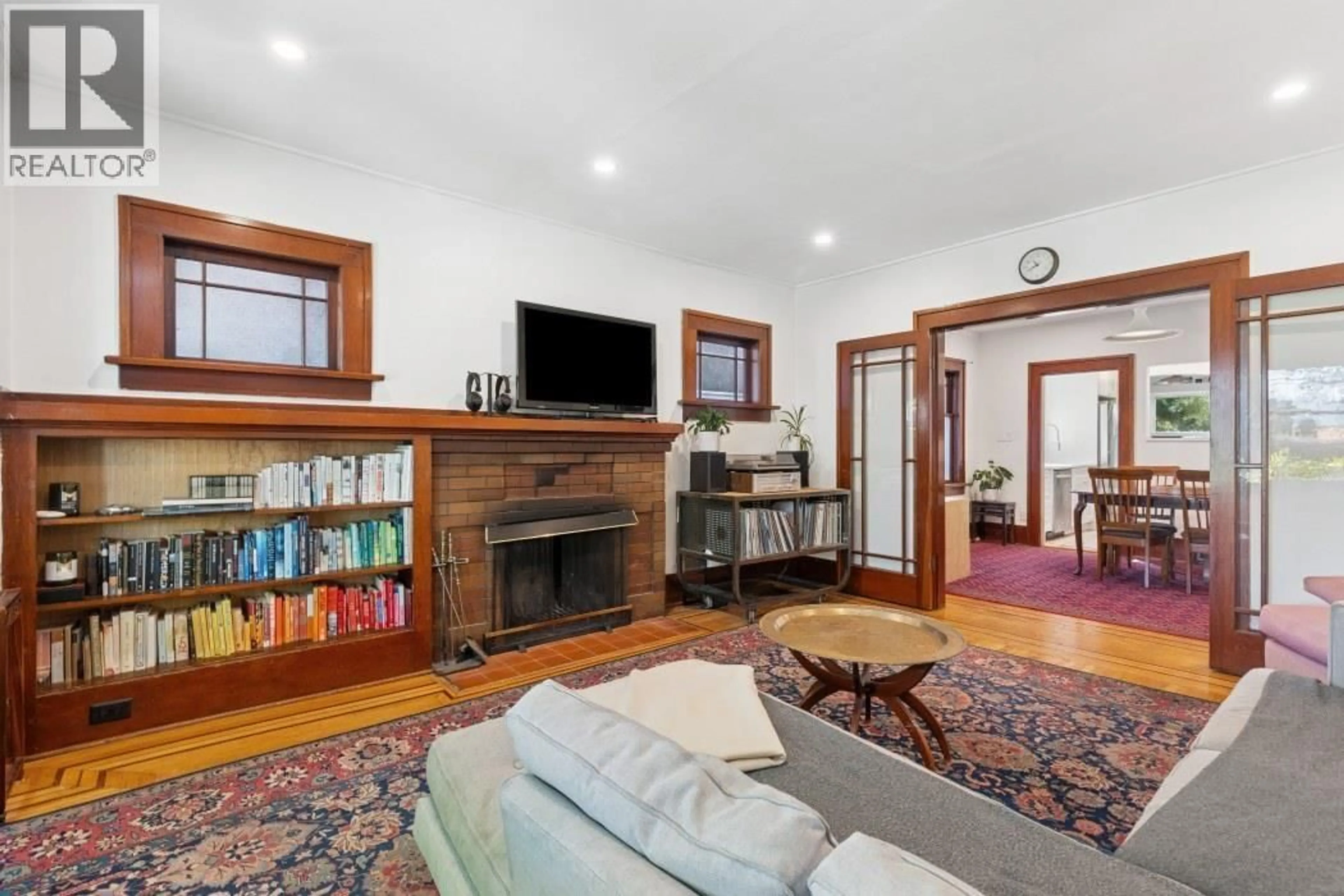 Living room with furniture, wood/laminate floor for 4188 13TH AVENUE, Vancouver British Columbia V6R2T6