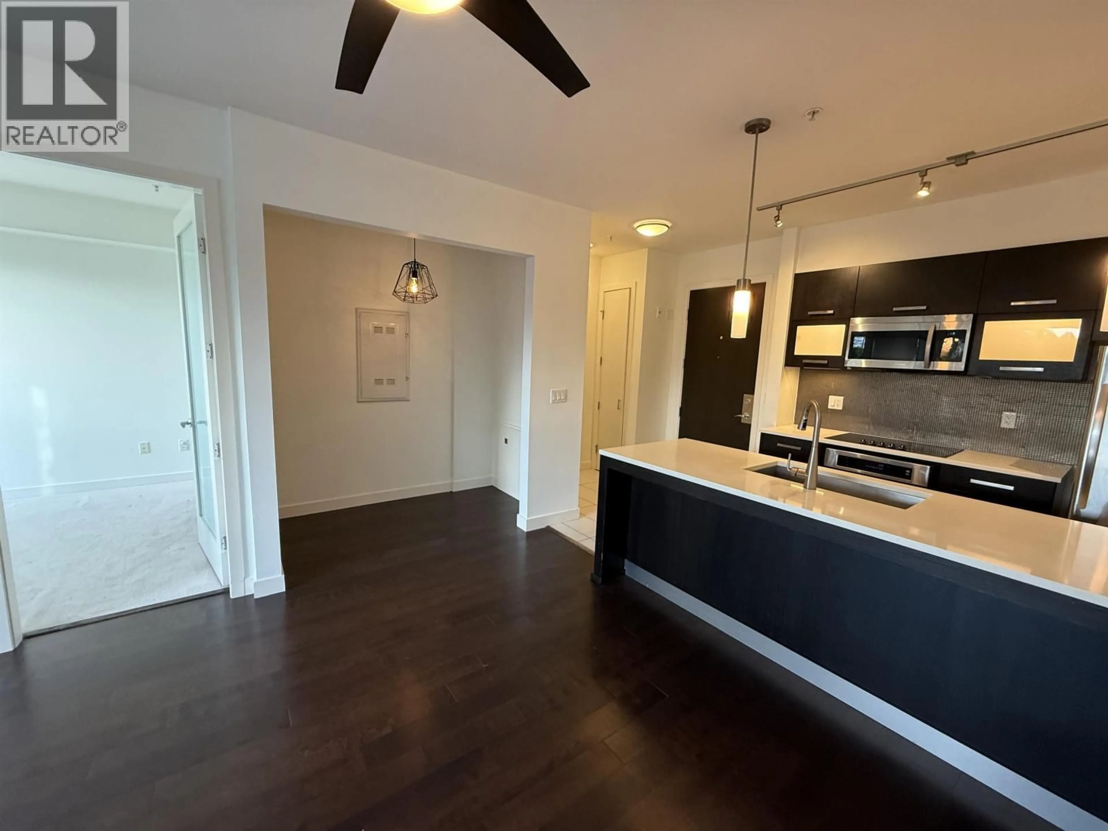Open concept kitchen, wood/laminate floor for 223 - 3333 MAIN STREET, Vancouver British Columbia V5V3M8