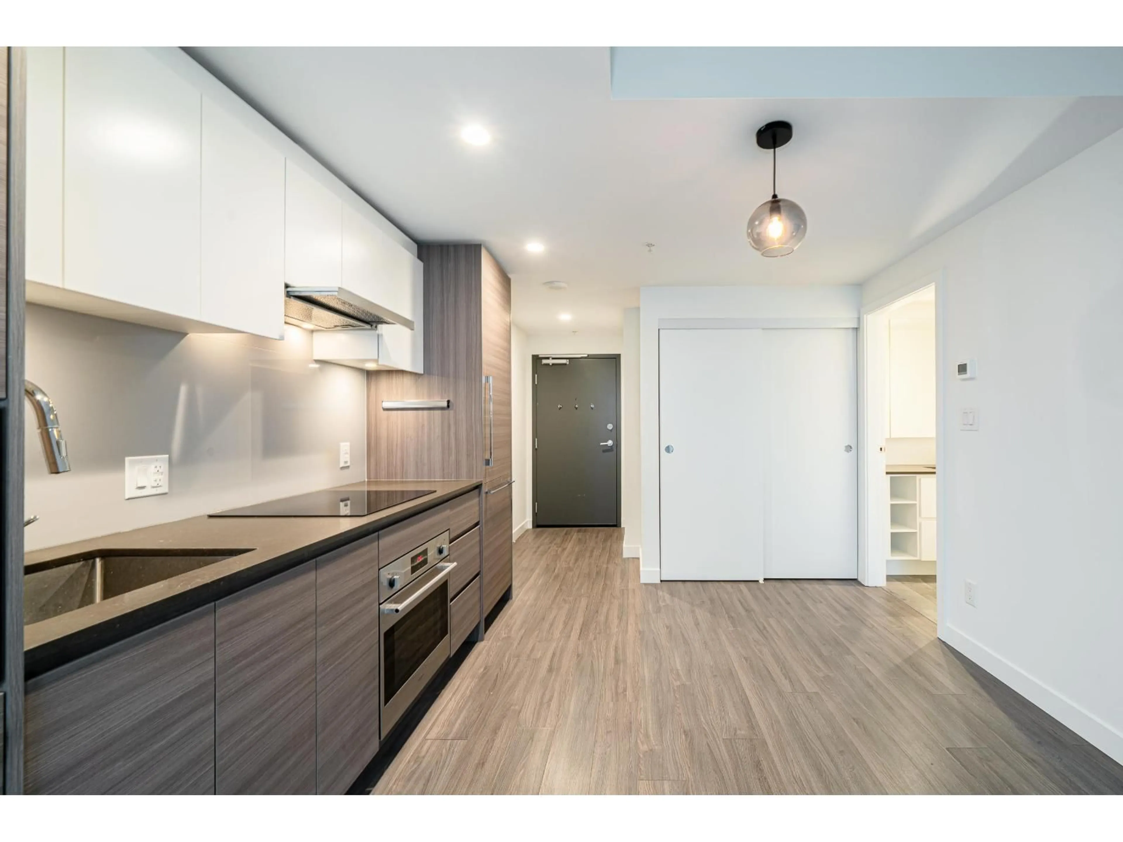 Open concept kitchen, wood/laminate floor for 2307 - 13655 FRASER HIGHWAY, Surrey British Columbia V3T0P8