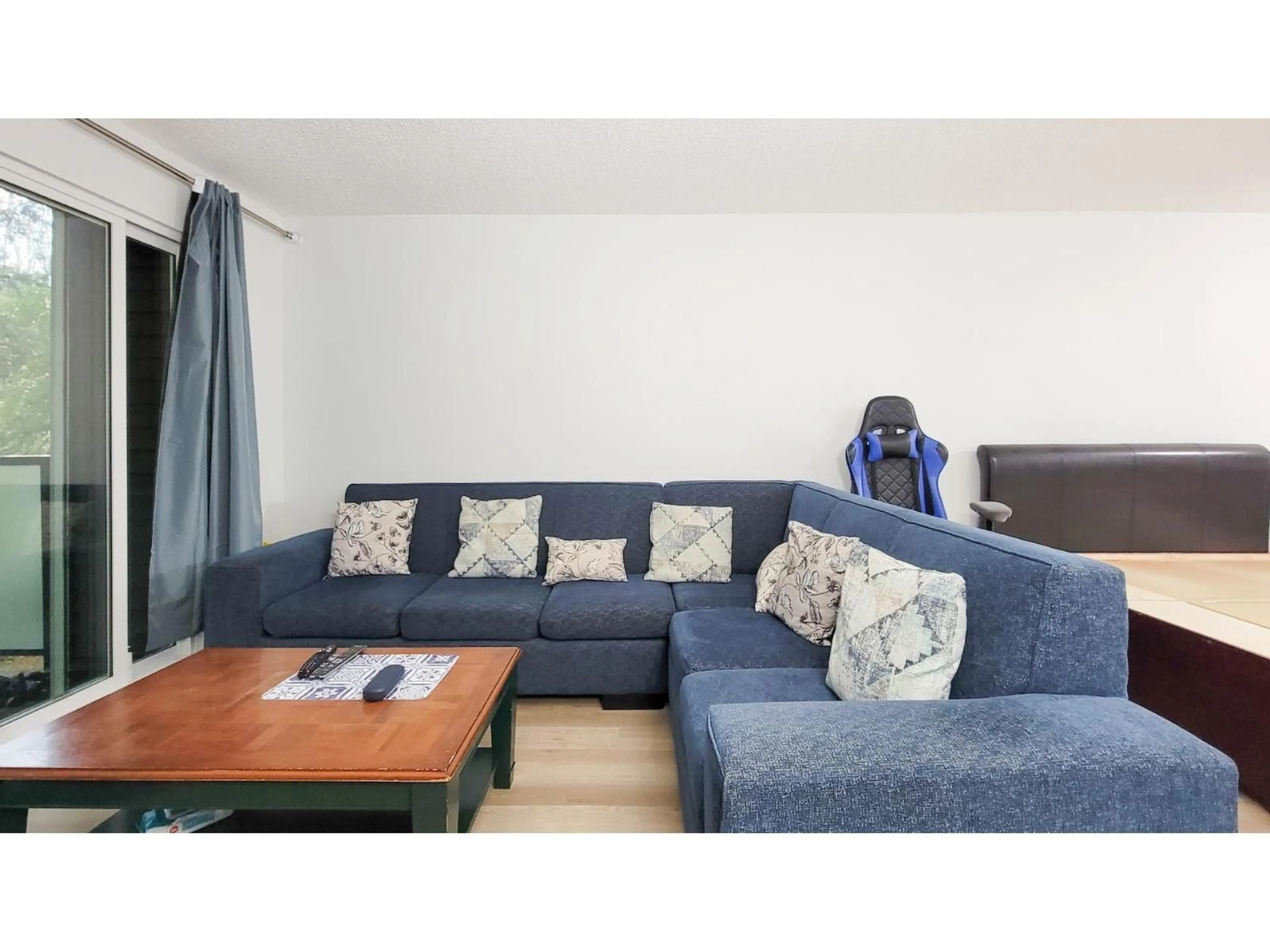 Living room with furniture, wood/laminate floor for 214 - 33400 BOURQUIN PLACE, Abbotsford British Columbia V2S5G3