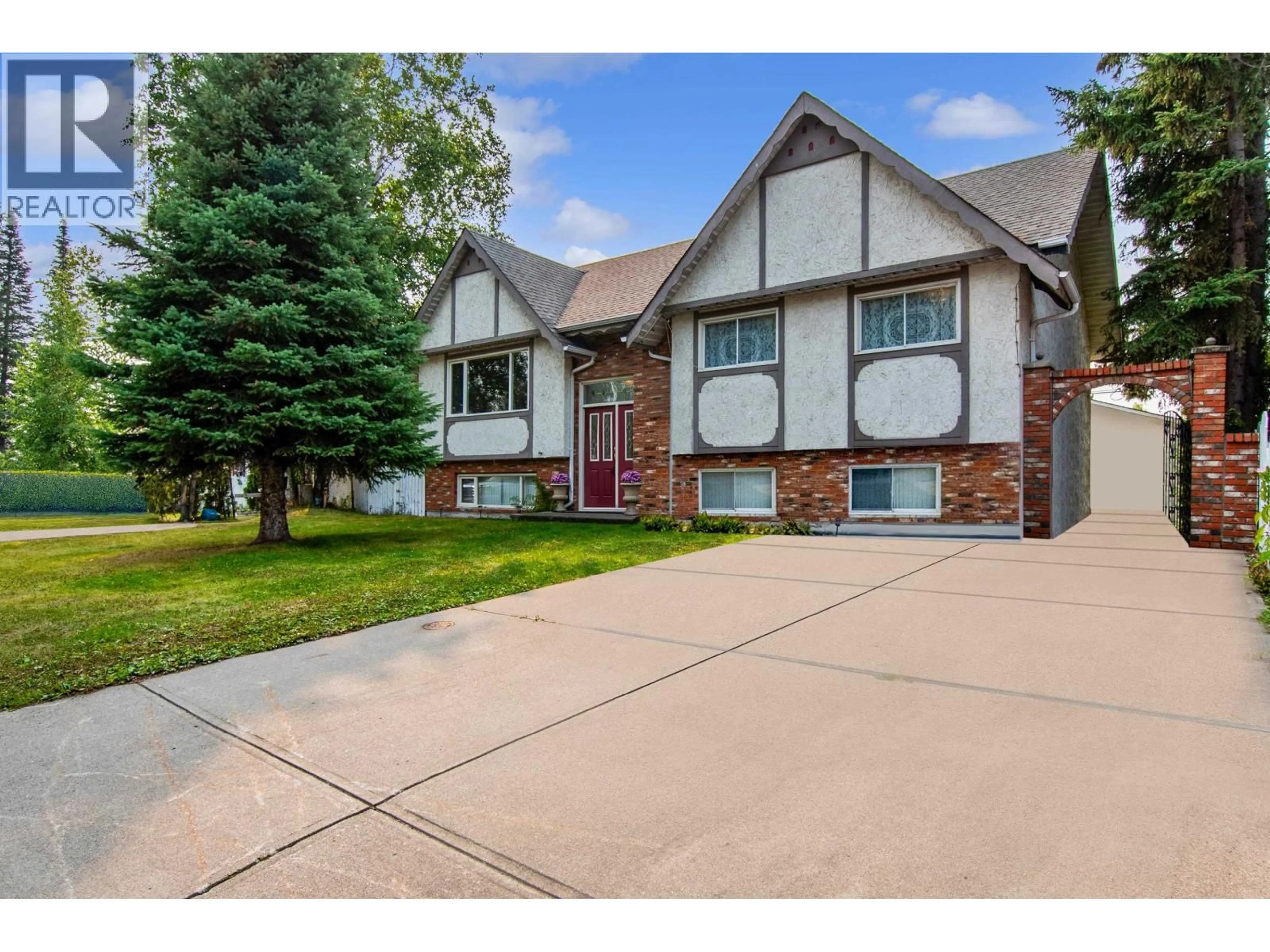 Home with brick exterior material, street for 2438 MCBRIDE CRESCENT, Prince George British Columbia V2M2A1