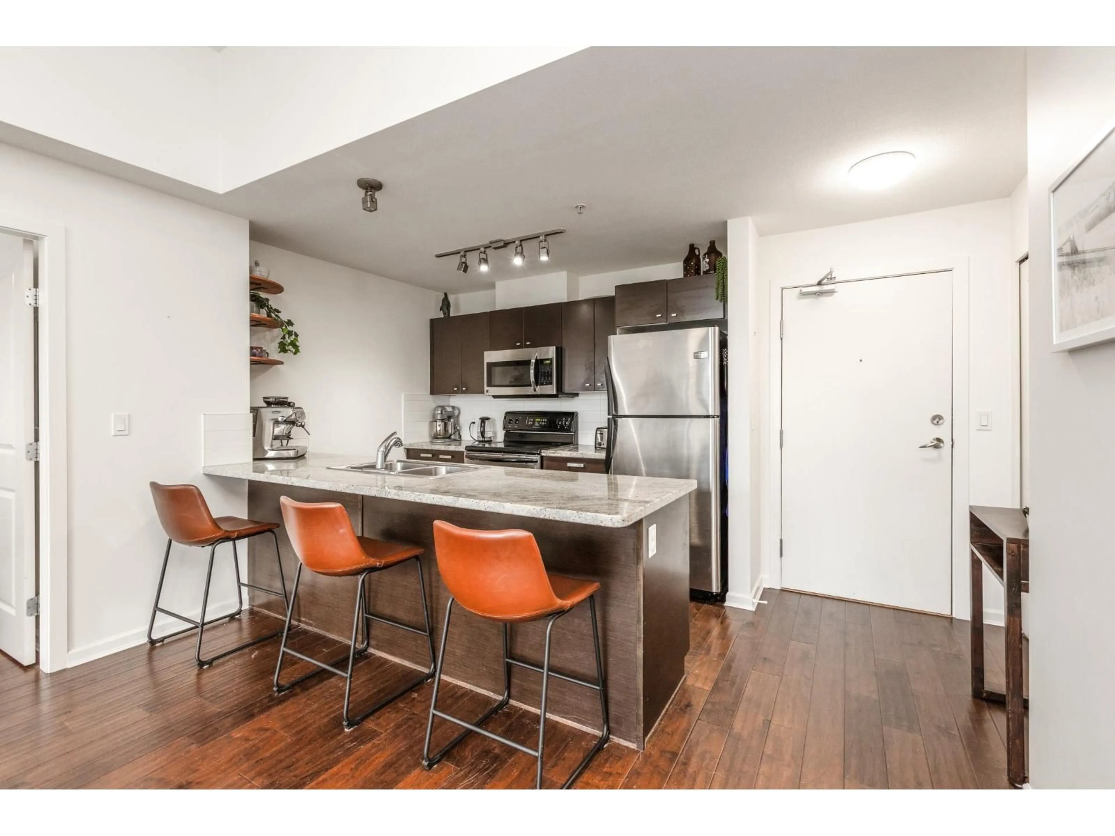 Open concept kitchen, wood/laminate floor for 401 - 18755 68 AVENUE, Surrey British Columbia V4N0Z9