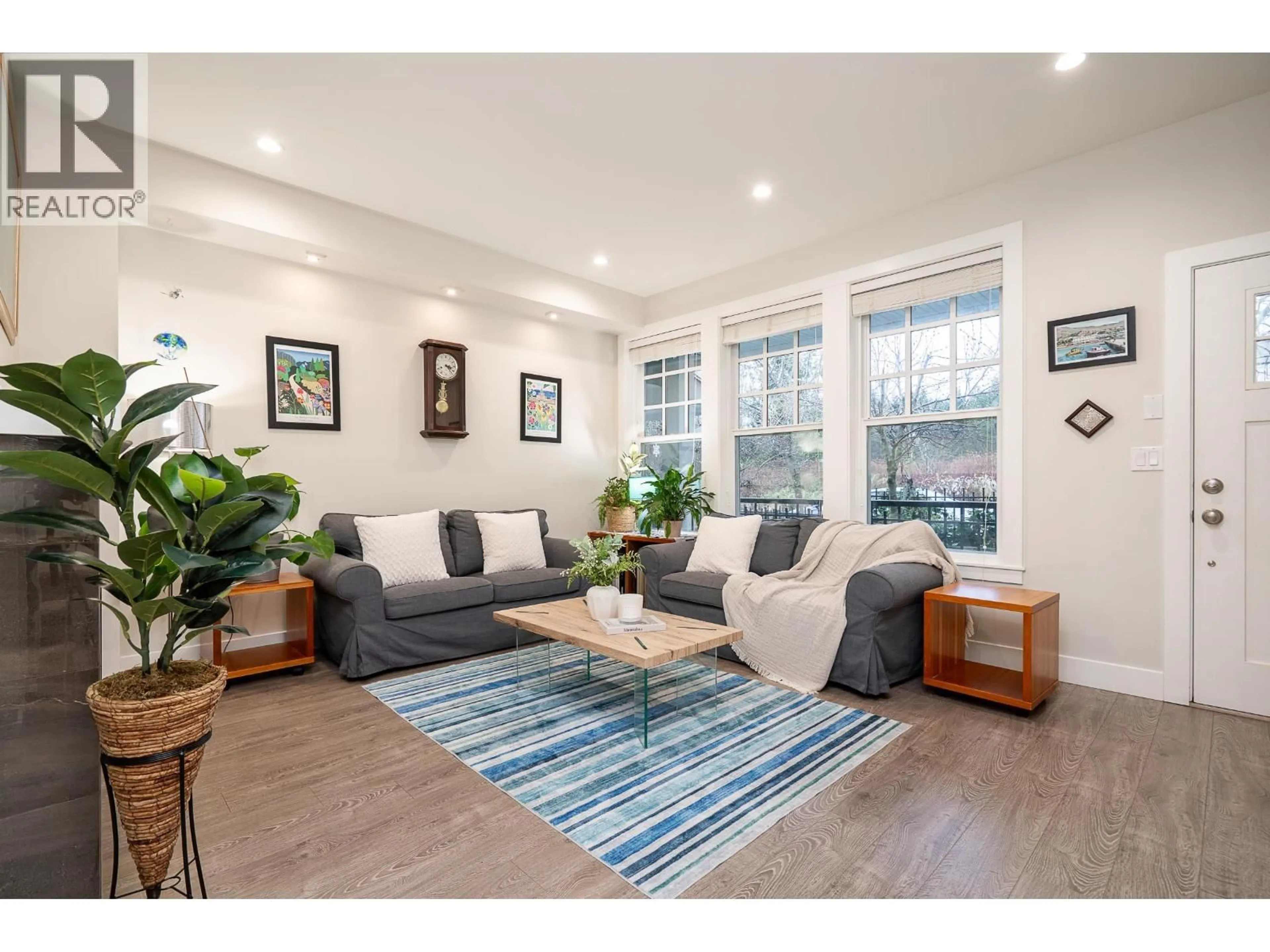 Living room with furniture, wood/laminate floor for 103 - 3410 QUEENSTON AVENUE, Coquitlam British Columbia V3E3H1