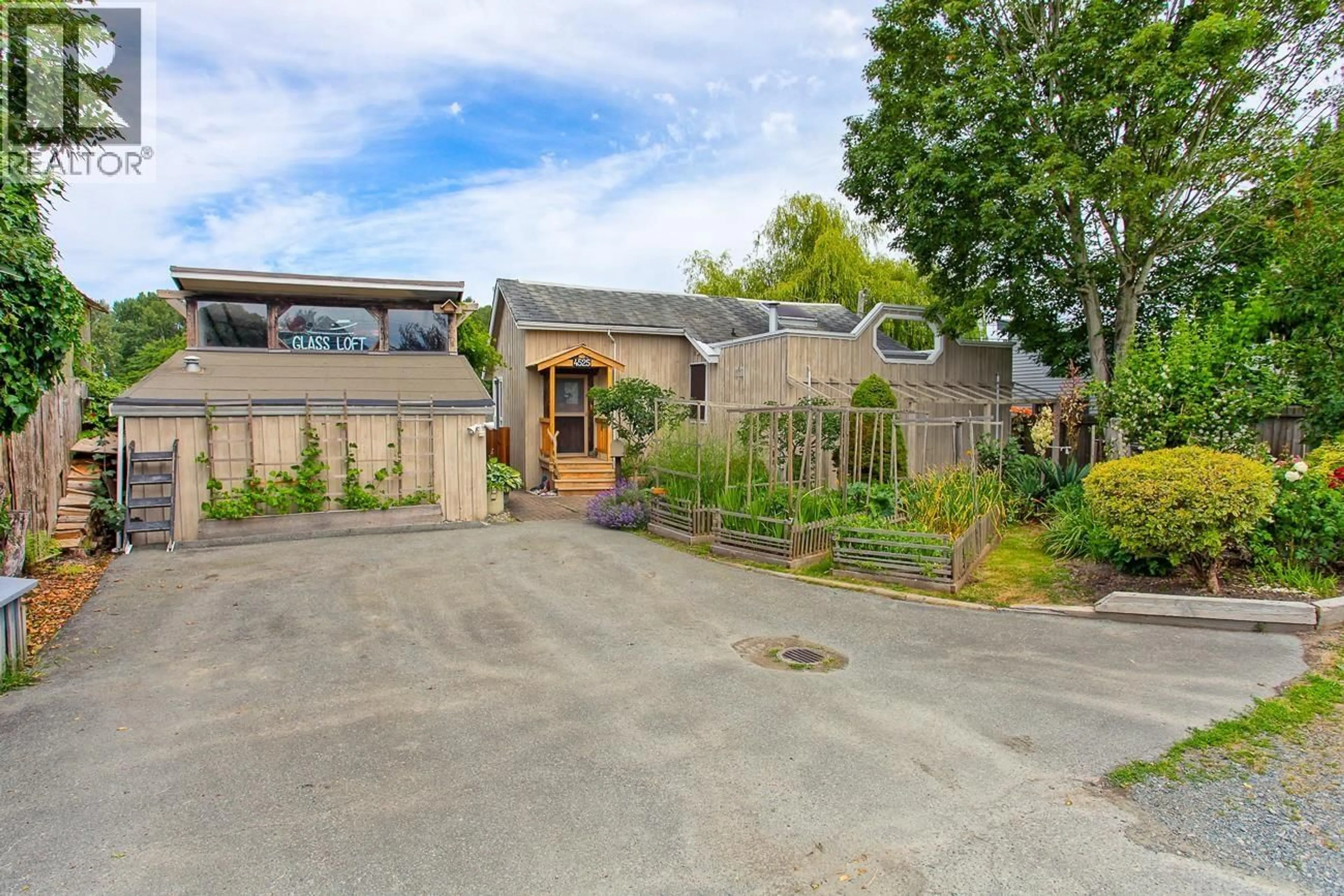 A pic from outside/outdoor area/front of a property/back of a property/a pic from drone, street for 4525 RIVER ROAD, Delta British Columbia V4K1R9