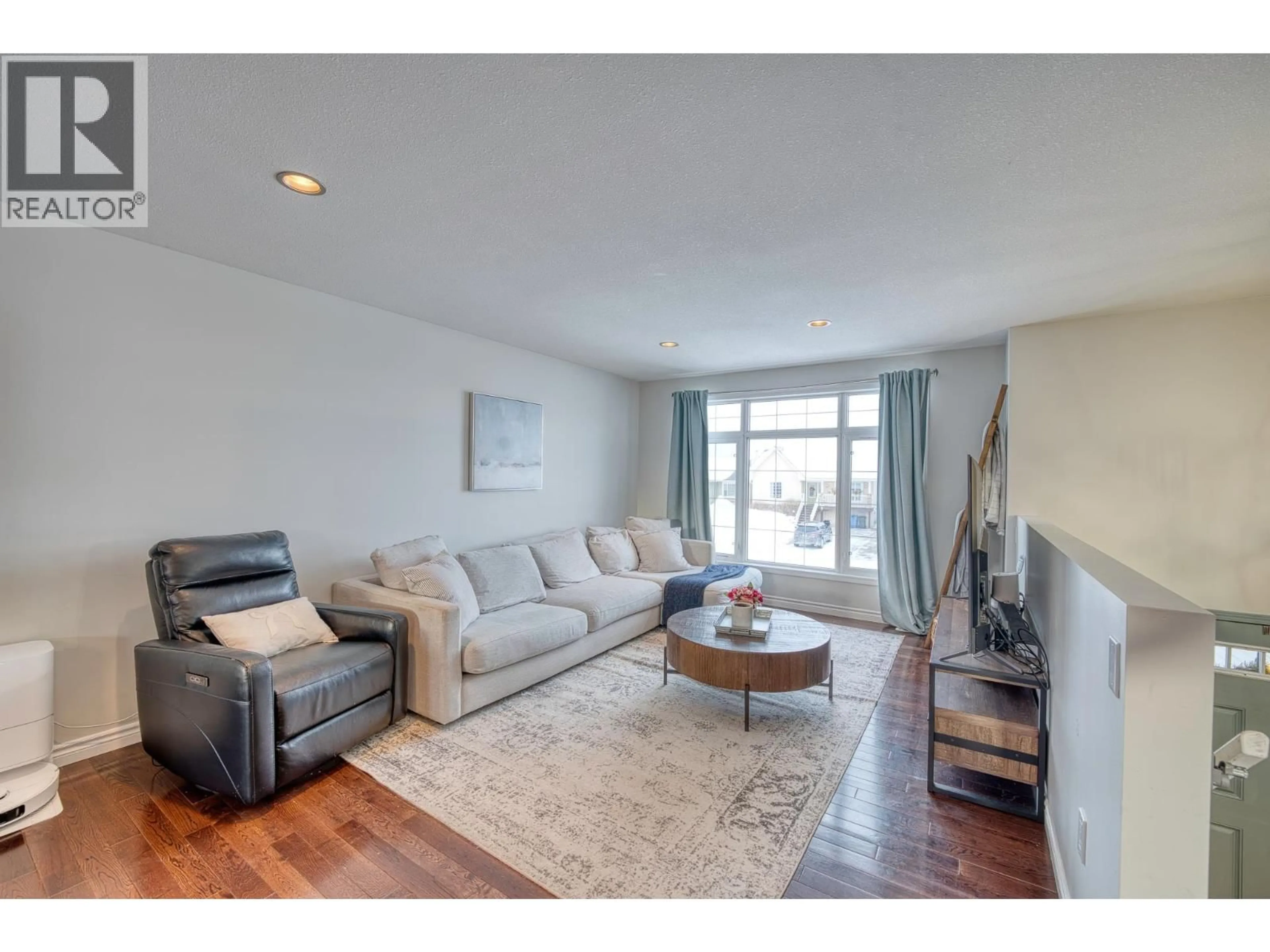 Living room with furniture, wood/laminate floor for 8707 113A AVENUE, Fort St. John British Columbia V1J0C4