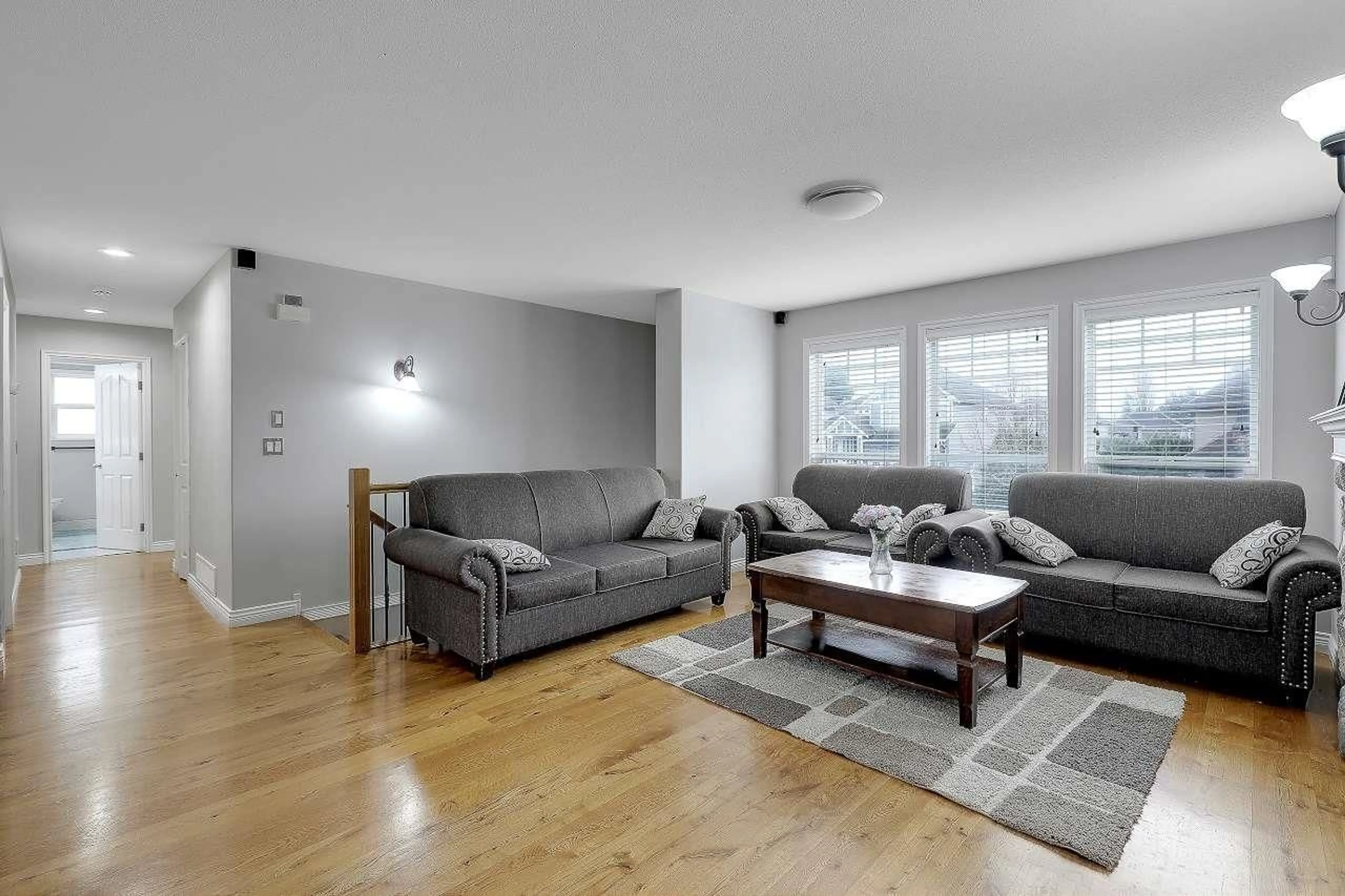 Living room with furniture, wood/laminate floor for 27951 JUNCTION AVENUE, Abbotsford British Columbia V4X2R6