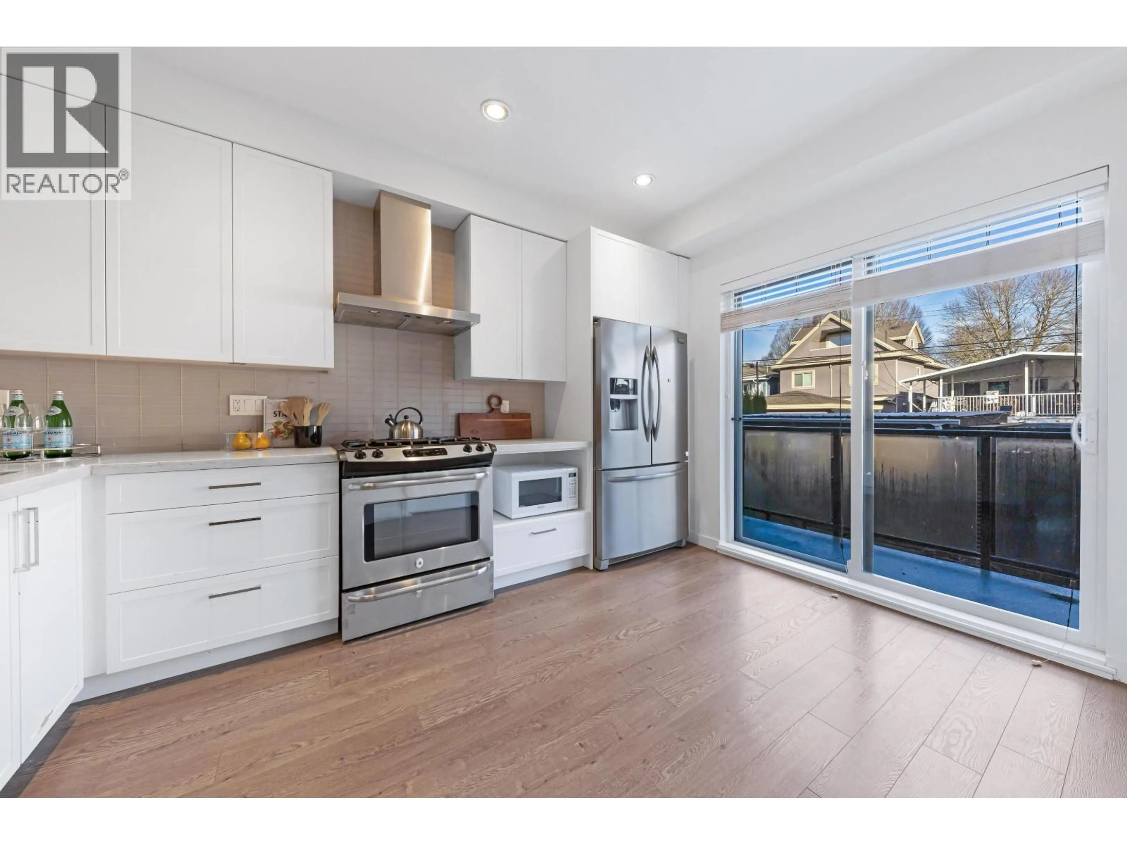 Open concept kitchen, wood/laminate floor for 2763 DUKE STREET, Vancouver British Columbia V5R4S8