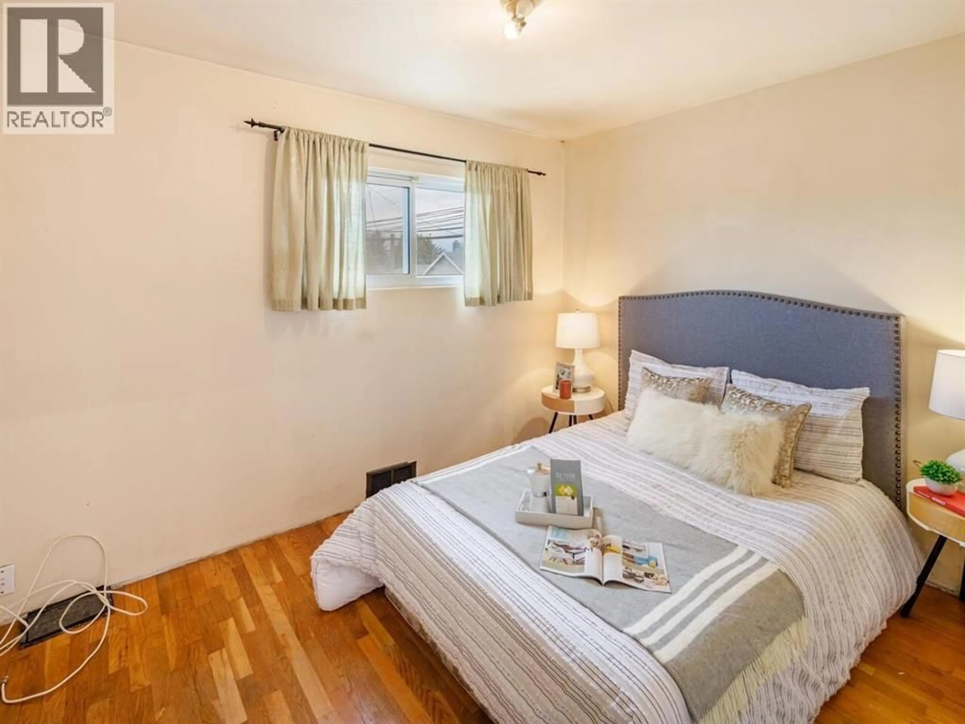 Bedroom with bed, wood/laminate floor for 3687 26TH AVENUE, Vancouver British Columbia V5R1M6