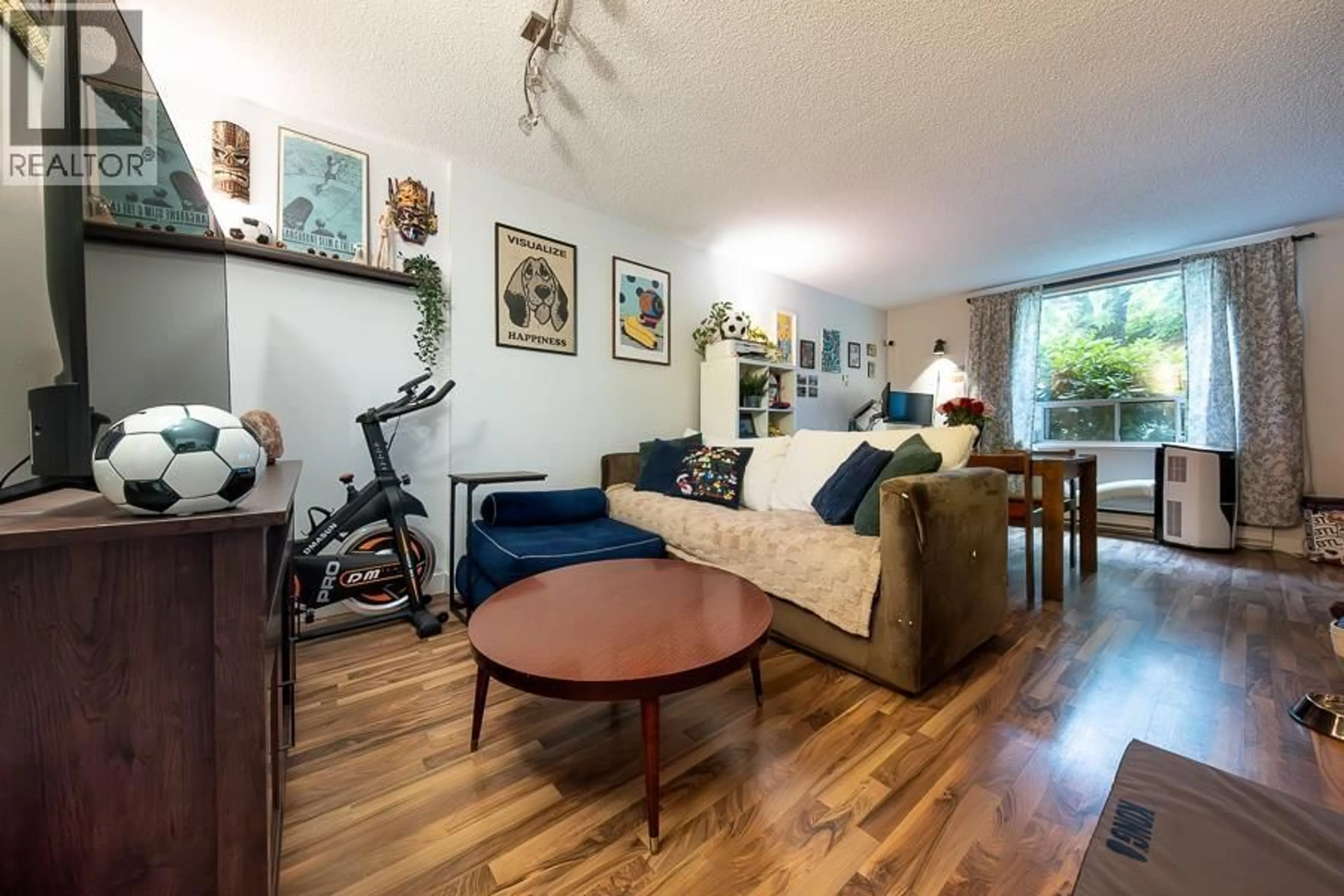 Living room with furniture, wood/laminate floor for 209 - 1345 COMOX STREET, Vancouver British Columbia V6E4E4