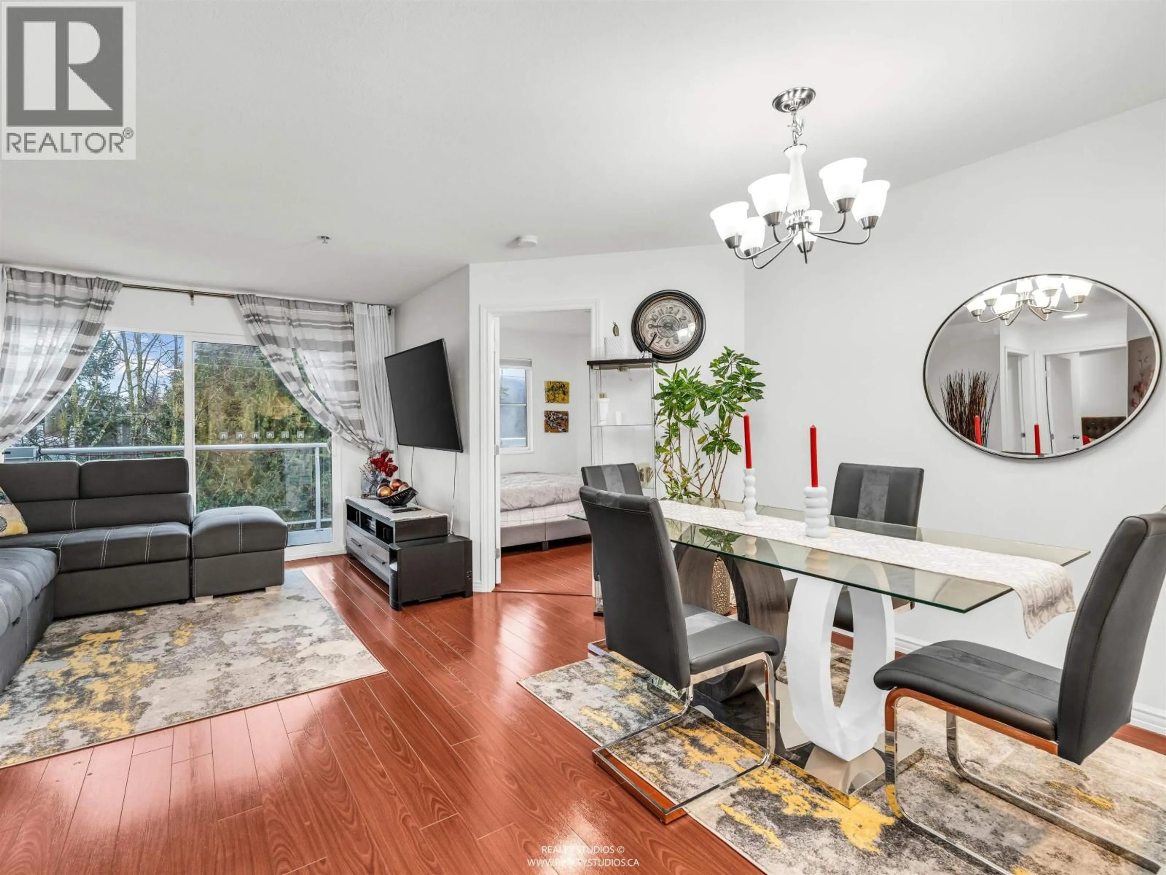 Living room with furniture, wood/laminate floor for 402 - 2983 CAMBRIDGE STREET, Port Coquitlam British Columbia V3B7N7