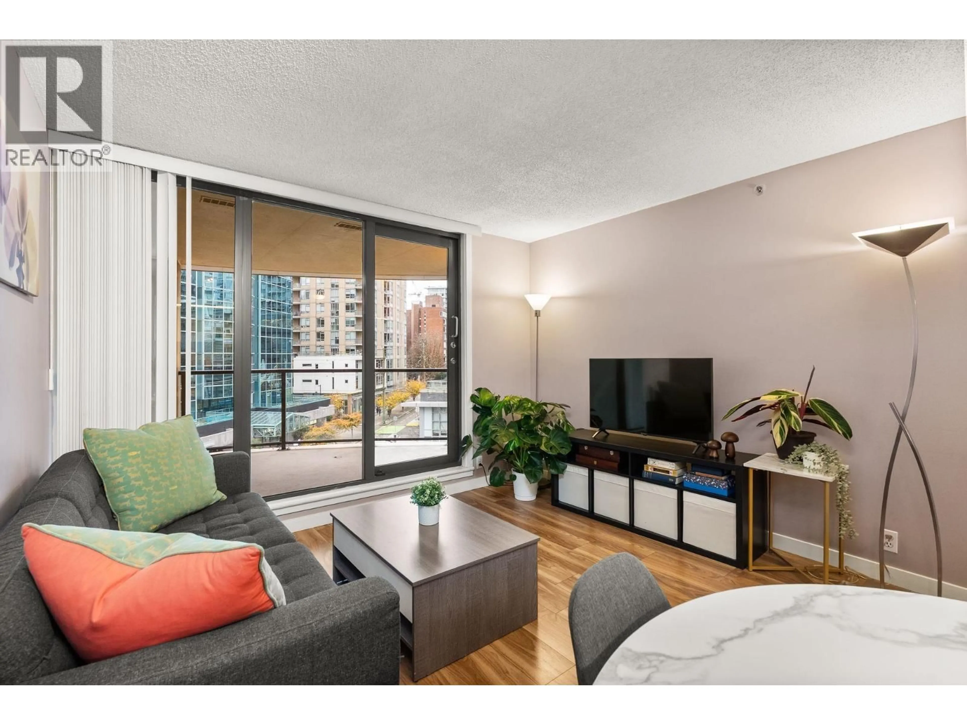 Living room with furniture, wood/laminate floor for 504 - 789 DRAKE STREET, Vancouver British Columbia V6Z2N7