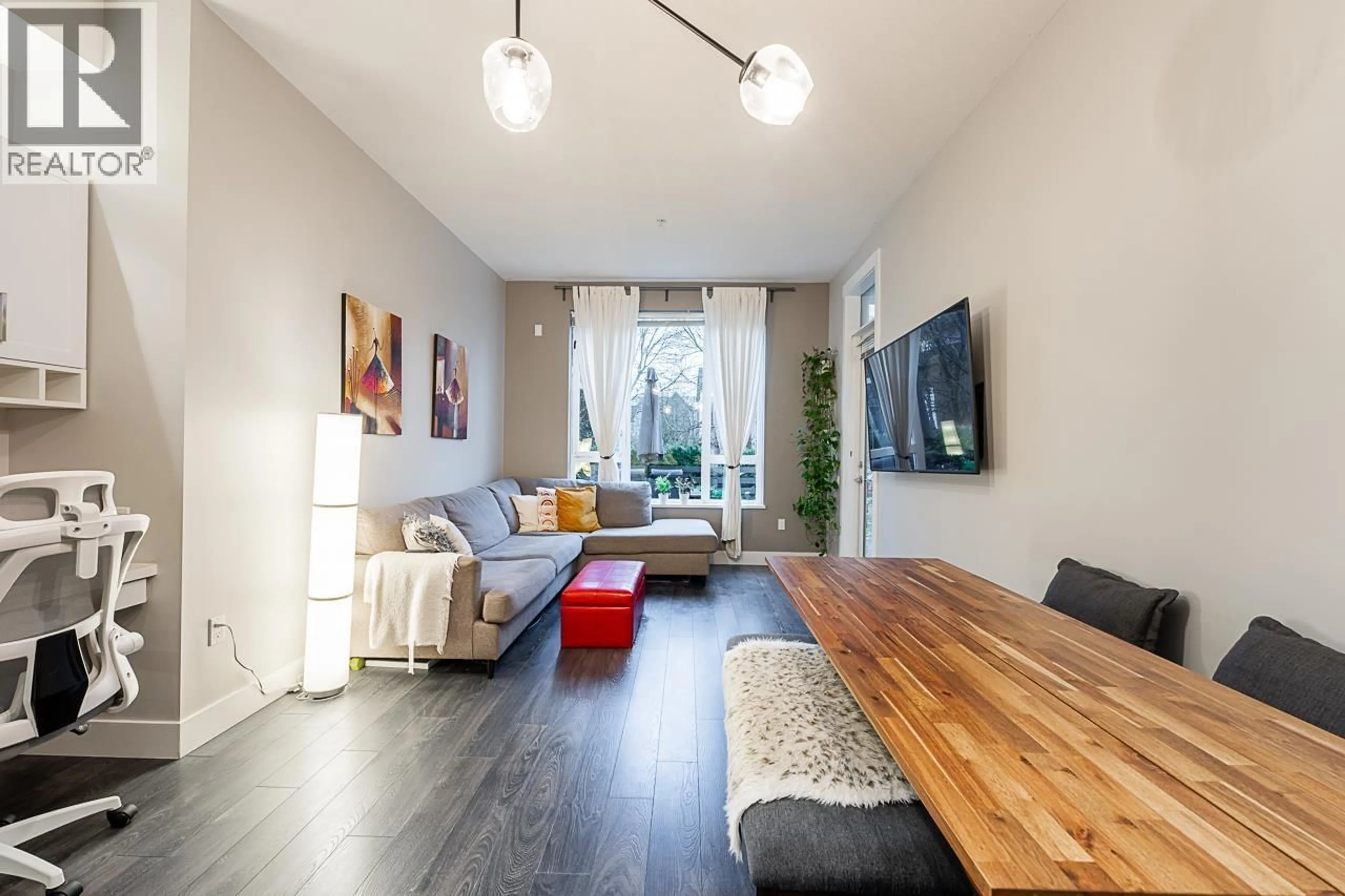 Living room with furniture, wood/laminate floor for 105 - 550 SEABORNE PLACE, Port Coquitlam British Columbia V3B0L3