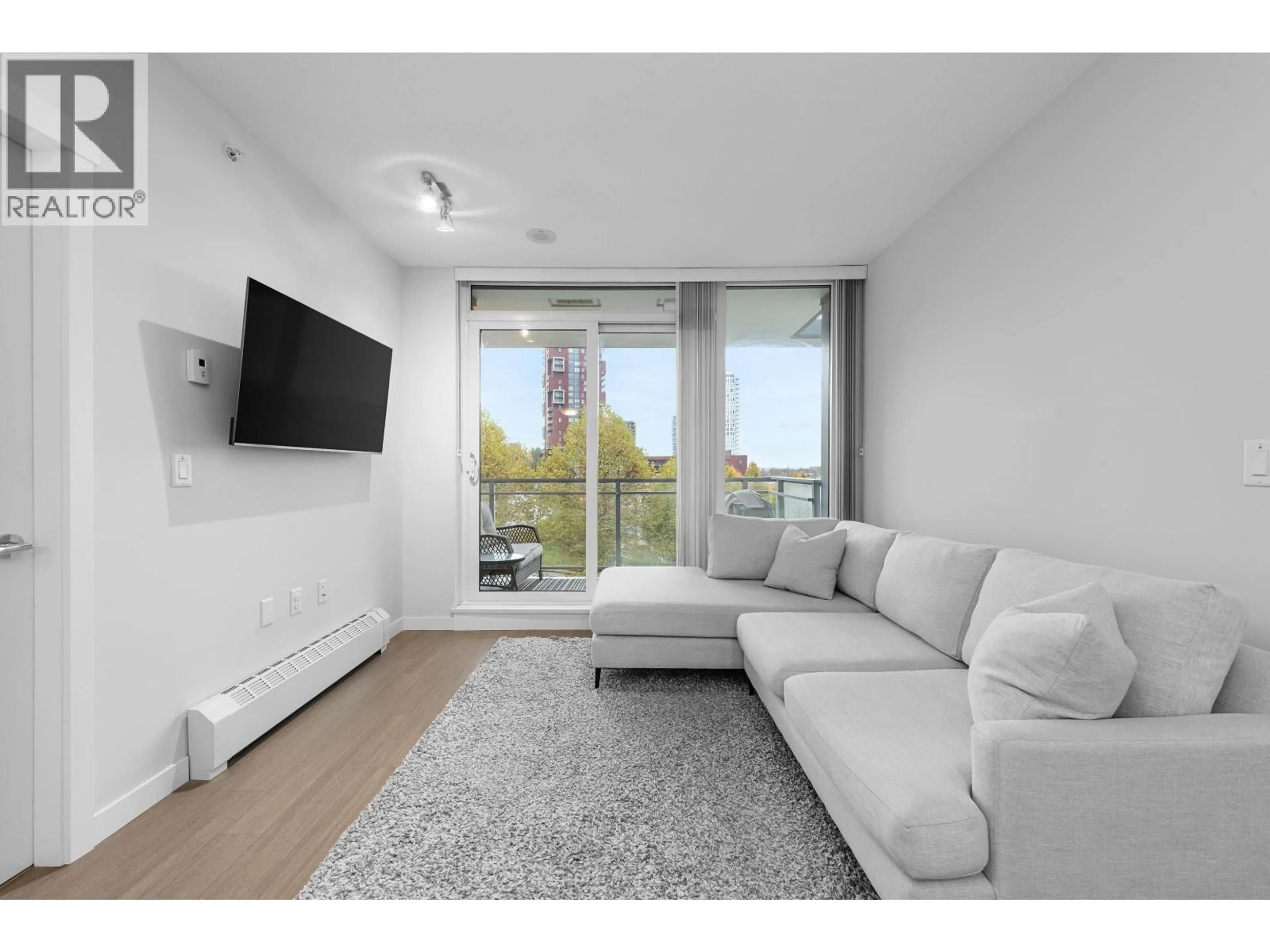 Living room with furniture, wood/laminate floor for 511 - 3281 KENT AVENUE NORTH AVENUE, Vancouver British Columbia V5S0C4