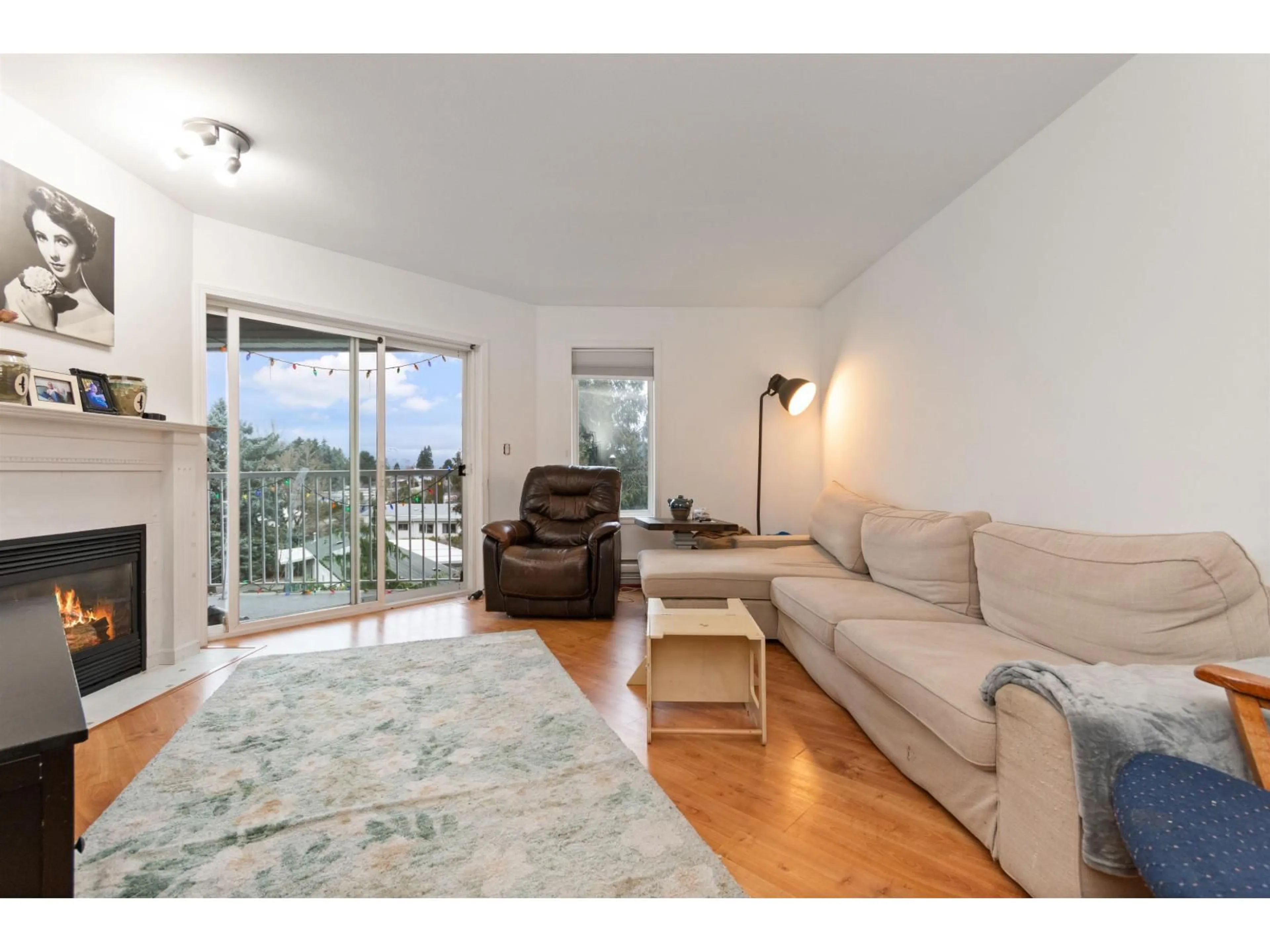 Living room with furniture, wood/laminate floor for 308 - 5765 VEDDER ROAD, Chilliwack British Columbia V2R1C3