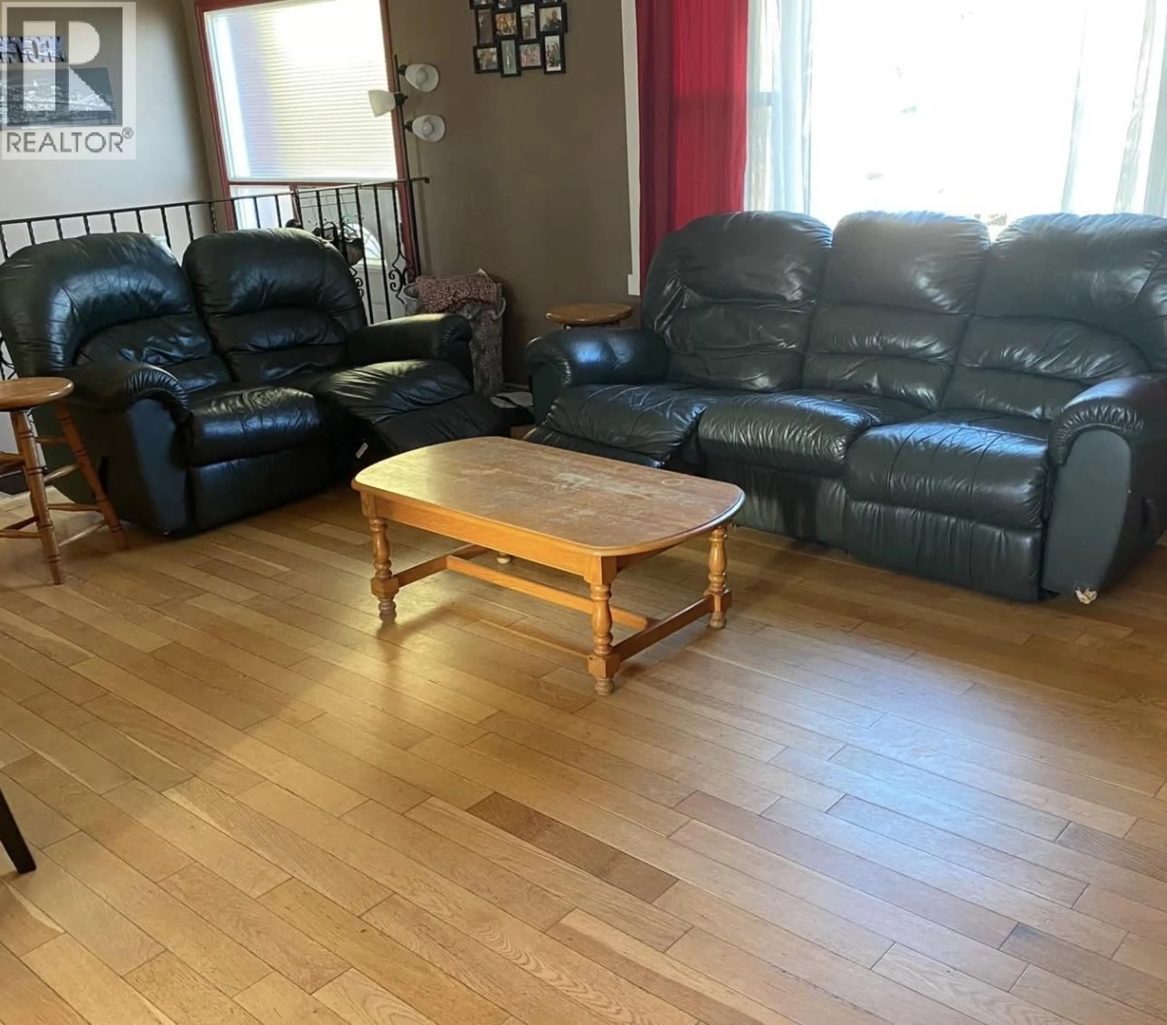 Living room with furniture, wood/laminate floor for 10615 105 AVENUE, Fort St. John British Columbia V1J2M9