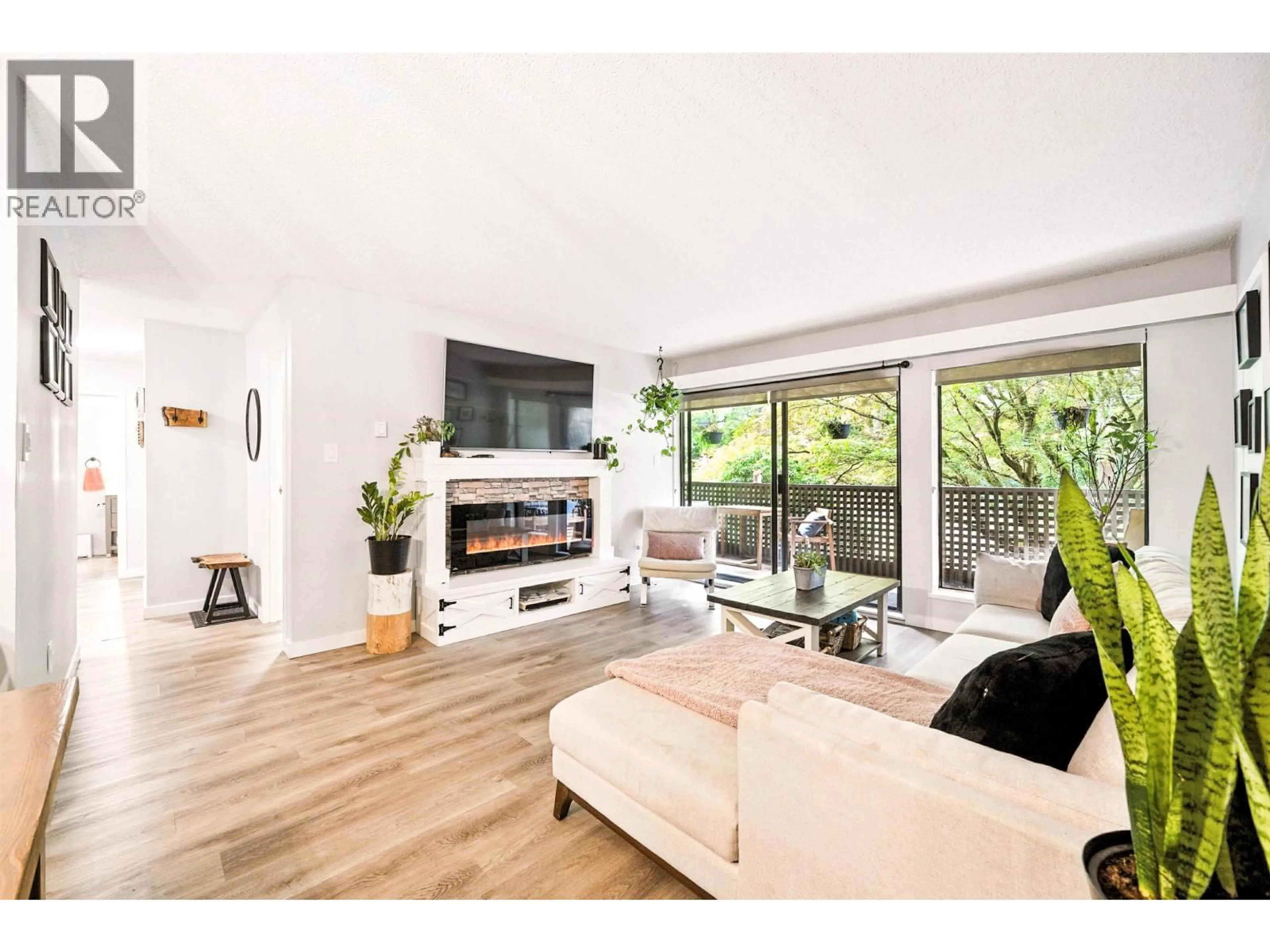 Living room with furniture, wood/laminate floor for 212 - 1955 WOODWAY PLACE, Burnaby British Columbia V5B4S5