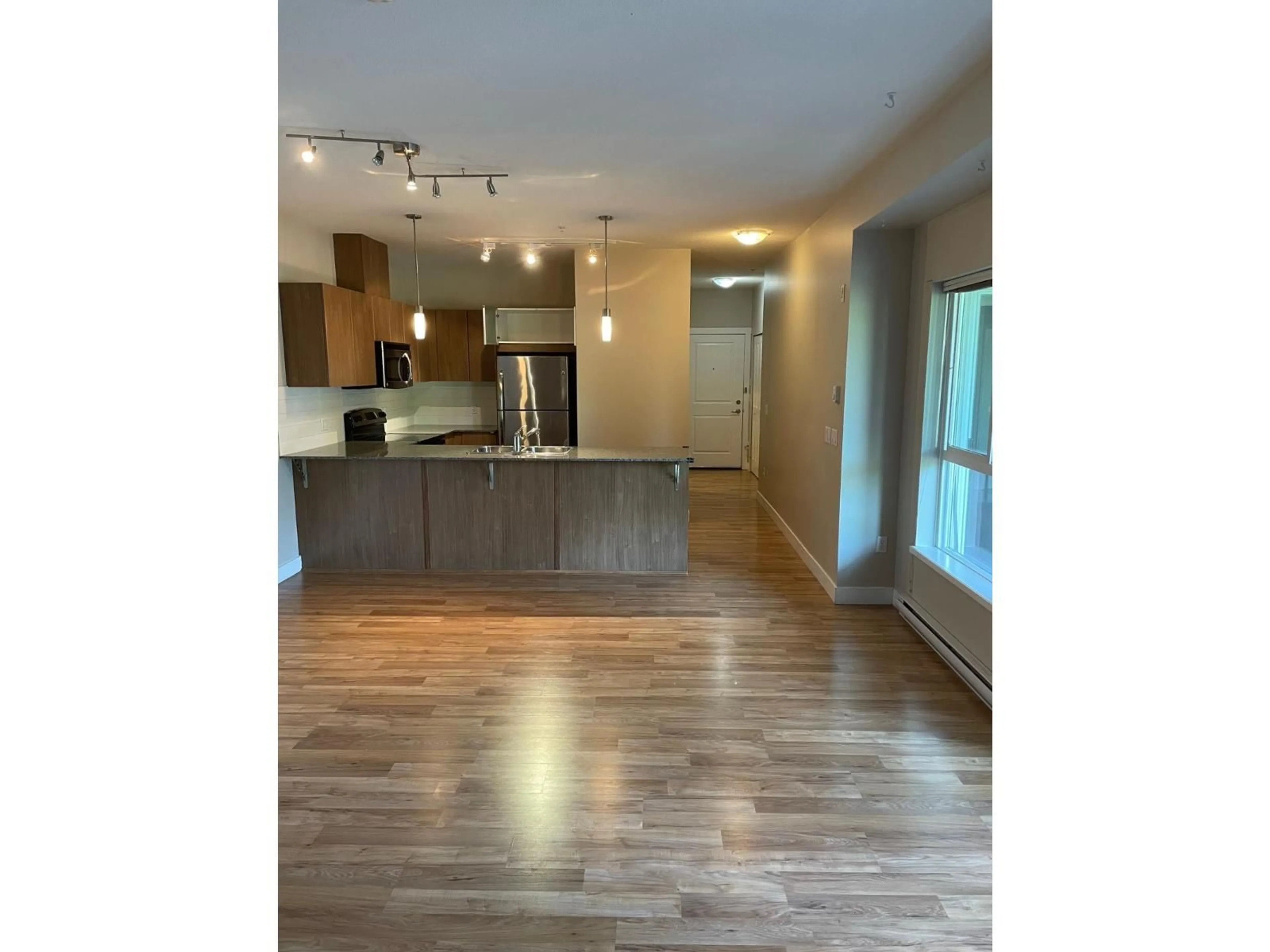 Open concept kitchen, wood/laminate floor for 324 - 9655 KING GEORGE BOULEVARD, Surrey British Columbia V3T0C7