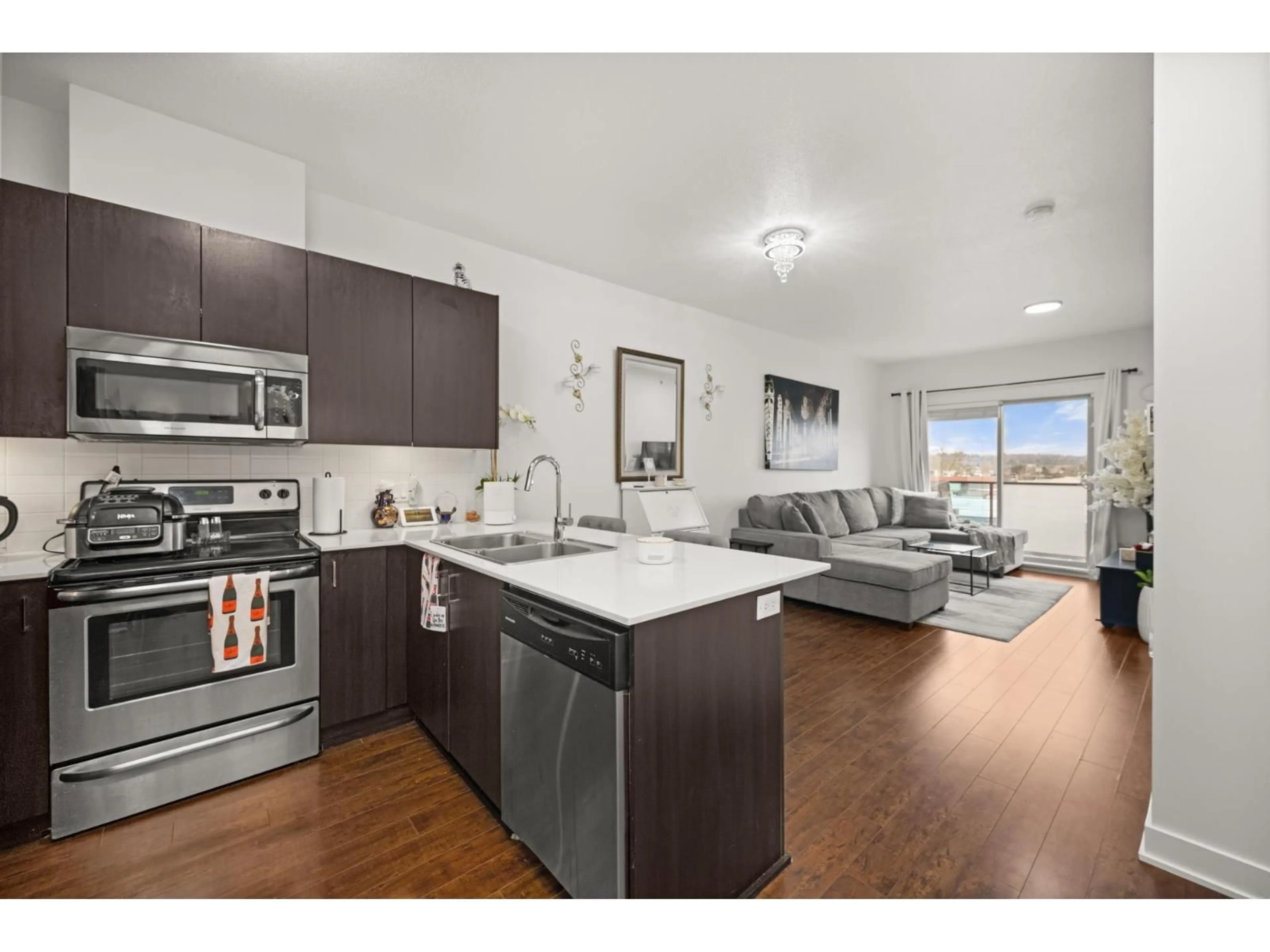 Open concept kitchen, wood/laminate floor for 403 - 20460 DOUGLAS CRESCENT, Langley British Columbia V3A0C6