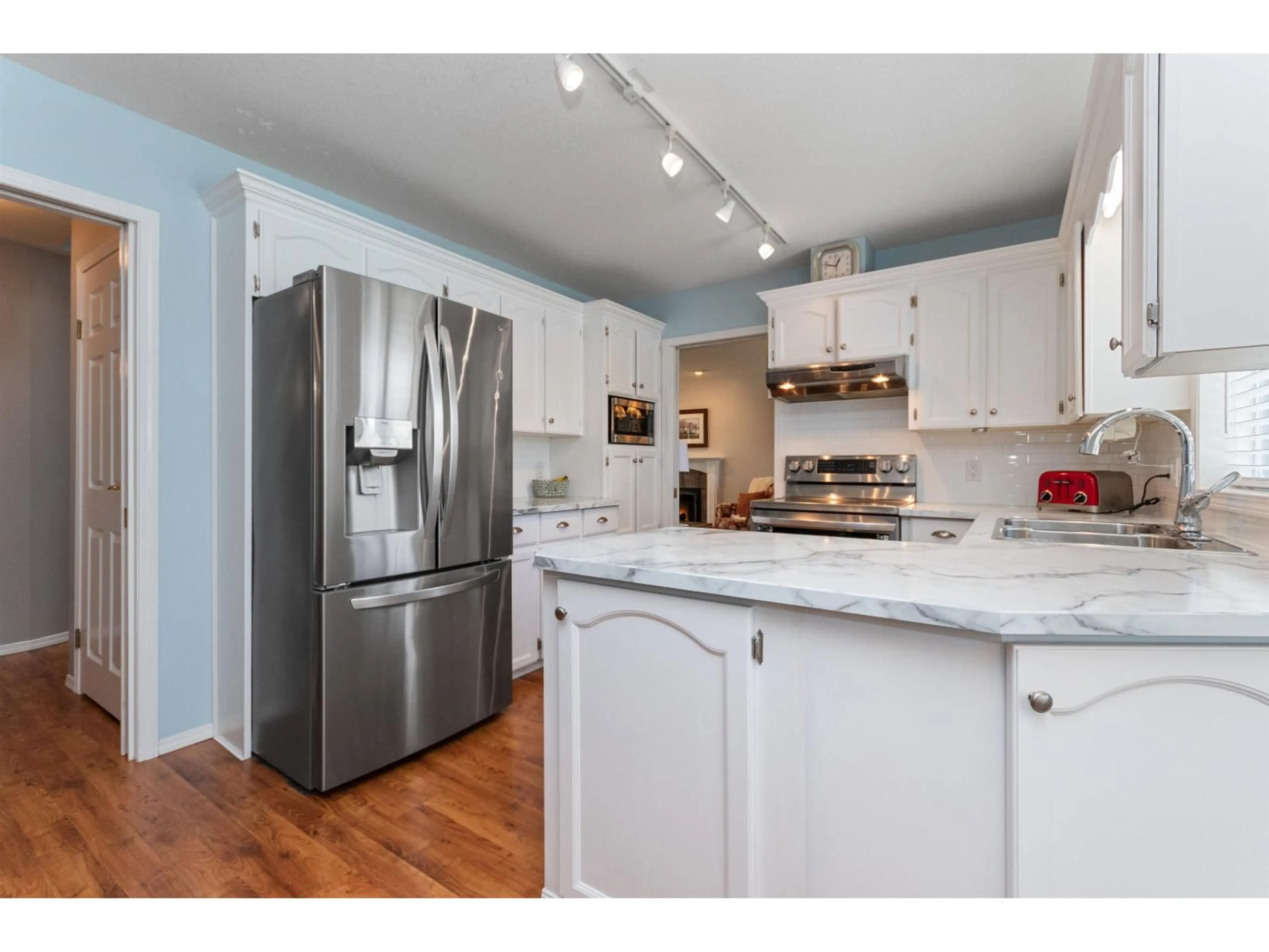 Open concept kitchen, wood/laminate floor for 6695 BEAUFORT ROAD, Chilliwack British Columbia V2R2C5