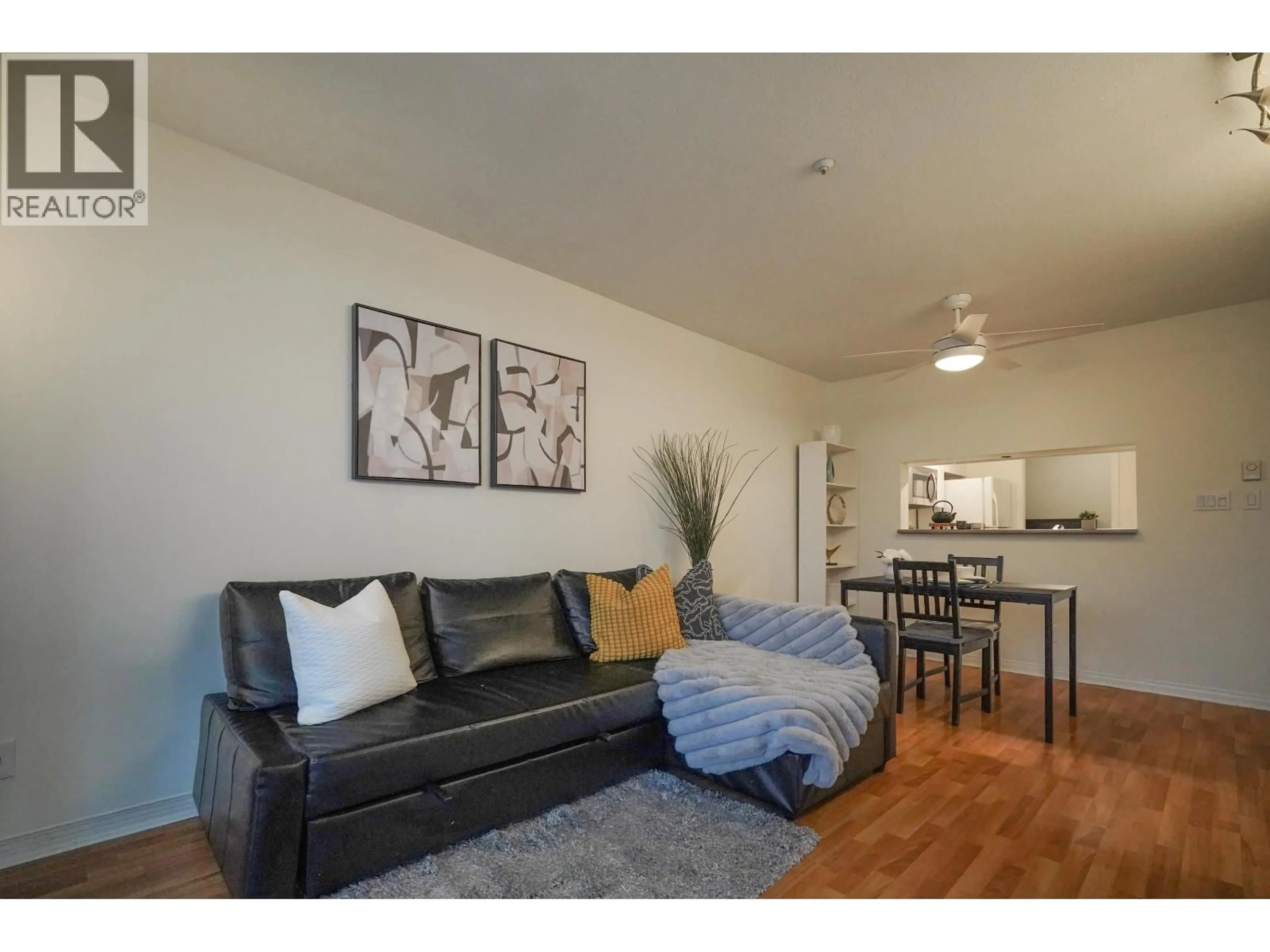 Living room with furniture, wood/laminate floor for 302 - 8420 JELLICOE STREET, Vancouver British Columbia V5S4T1