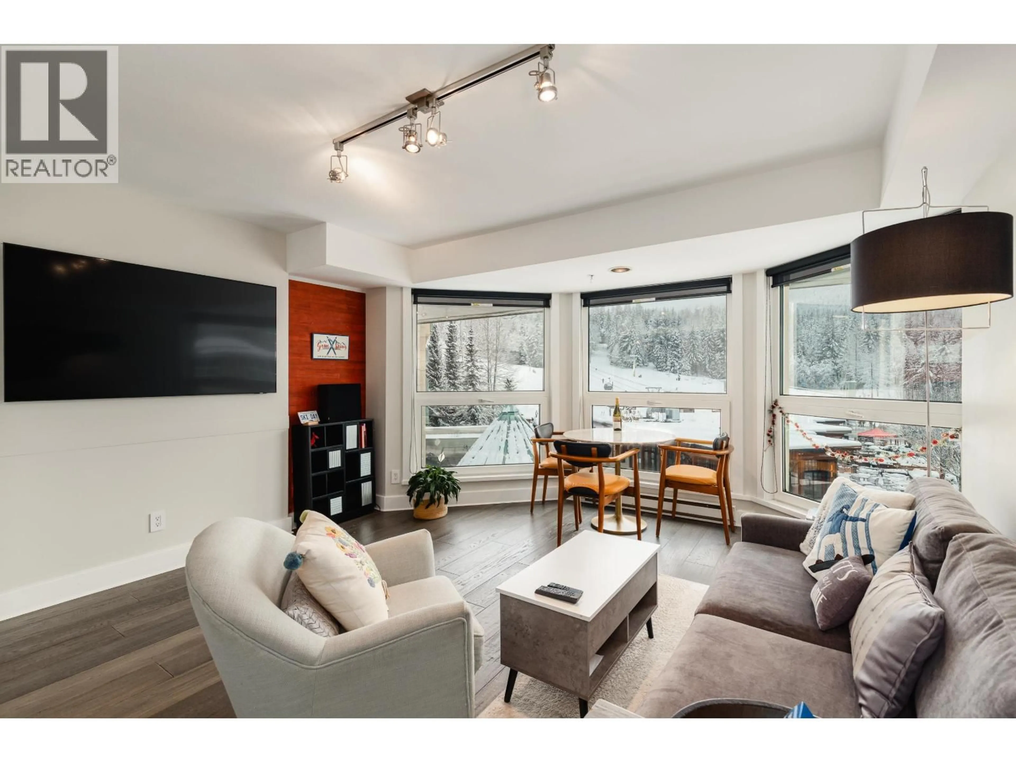 Living room with furniture, wood/laminate floor for 415 - 4557 BLACKCOMB WAY, Whistler British Columbia V8E0Y2