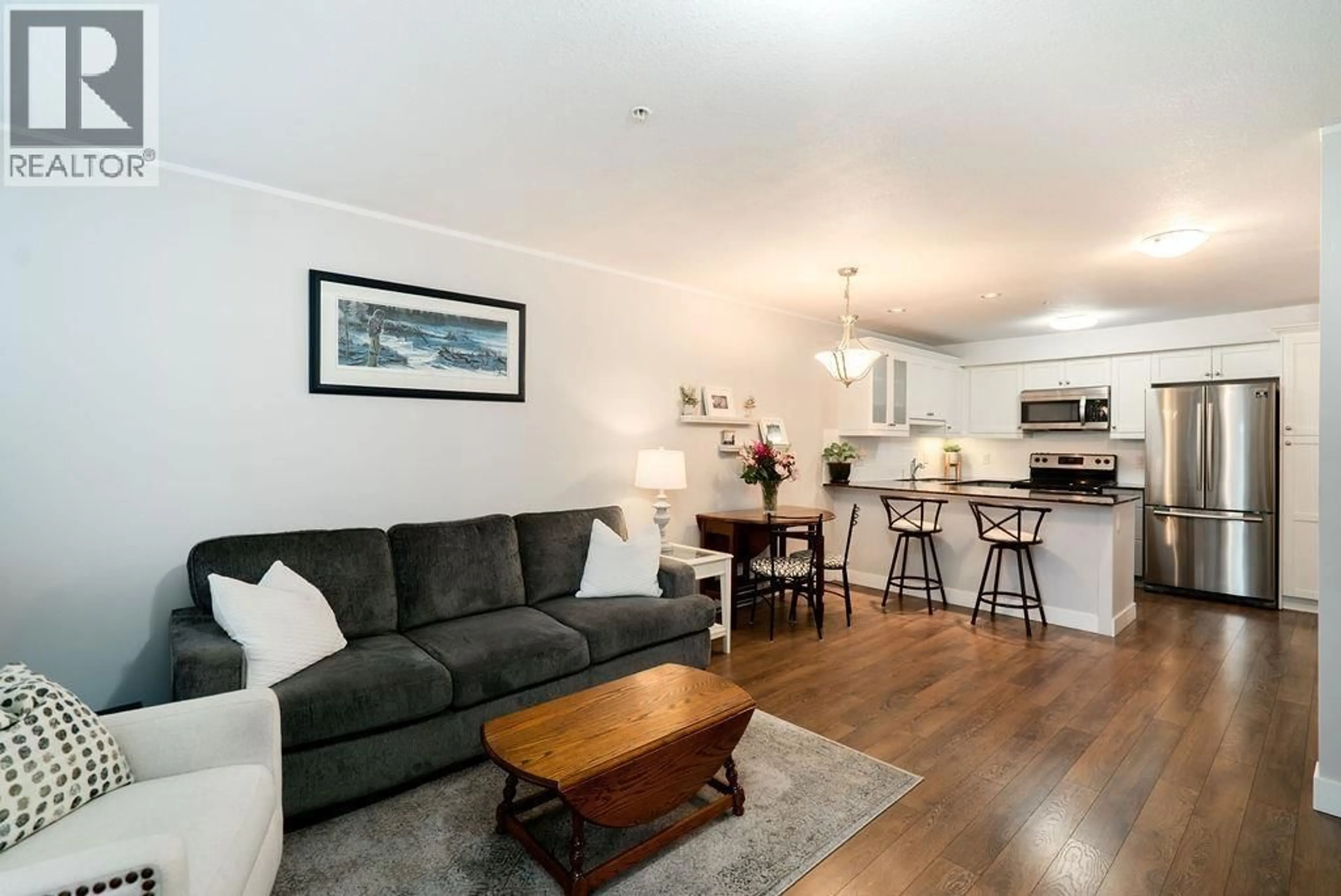 Living room with furniture, wood/laminate floor for 111 - 1969 WESTMINSTER AVENUE, Port Coquitlam British Columbia V3B1E7