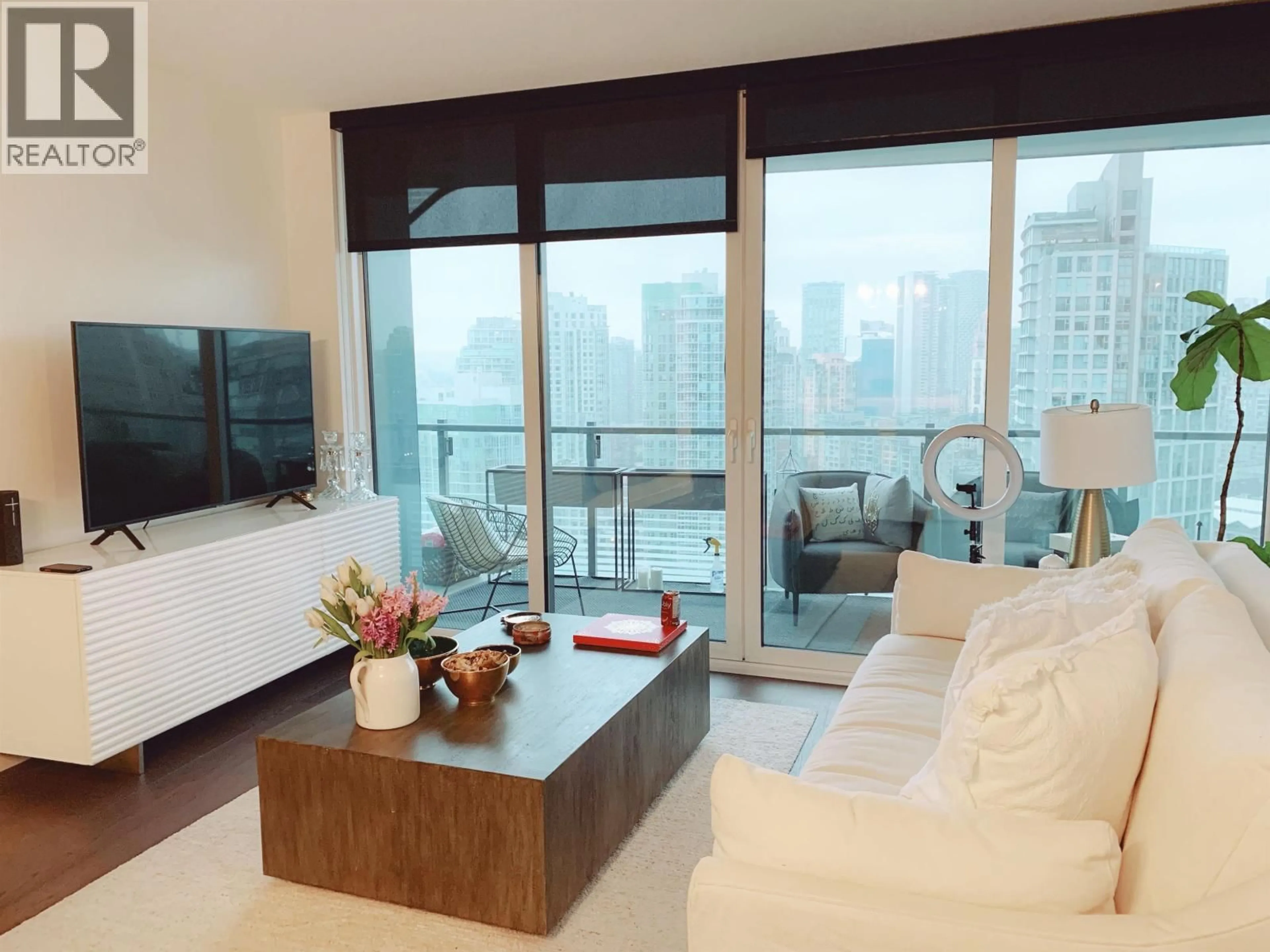 Living room with furniture, wood/laminate floor for 2620 - 89 NELSON STREET, Vancouver British Columbia V6Z0E7