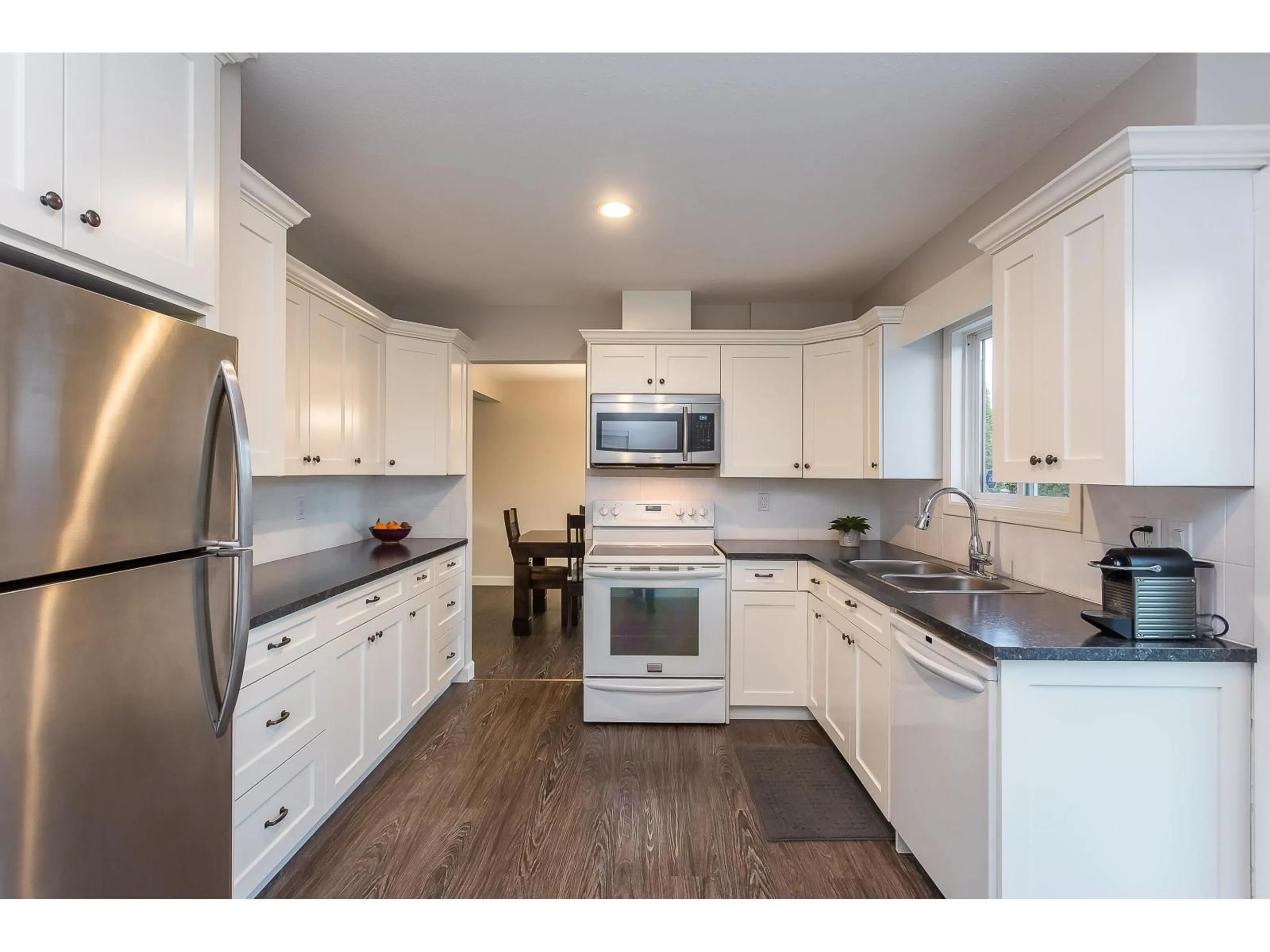Open concept kitchen, wood/laminate floor for 9966 MERRITT DRIVE, Chilliwack British Columbia V2P7B7