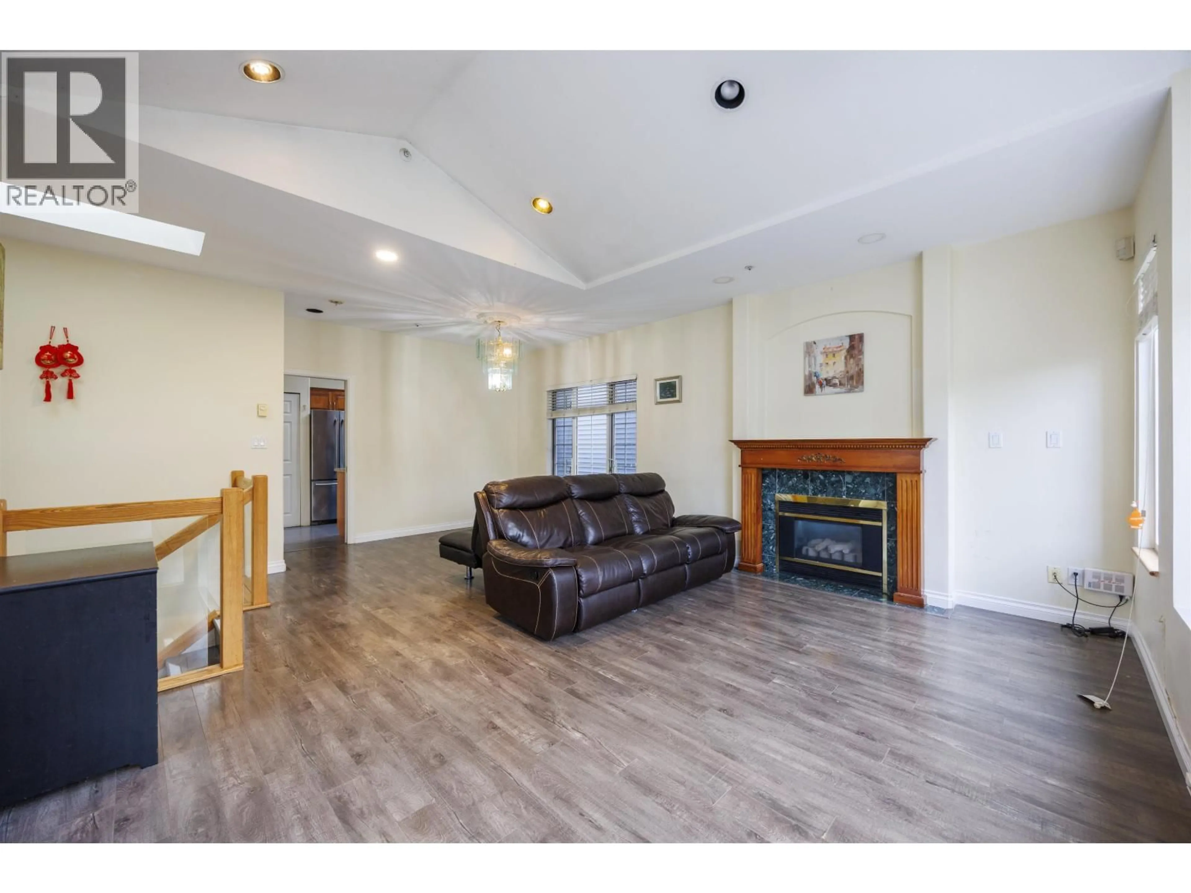 Living room with furniture, wood/laminate floor for 4774 KNIGHT STREET, Vancouver British Columbia V5N3N2