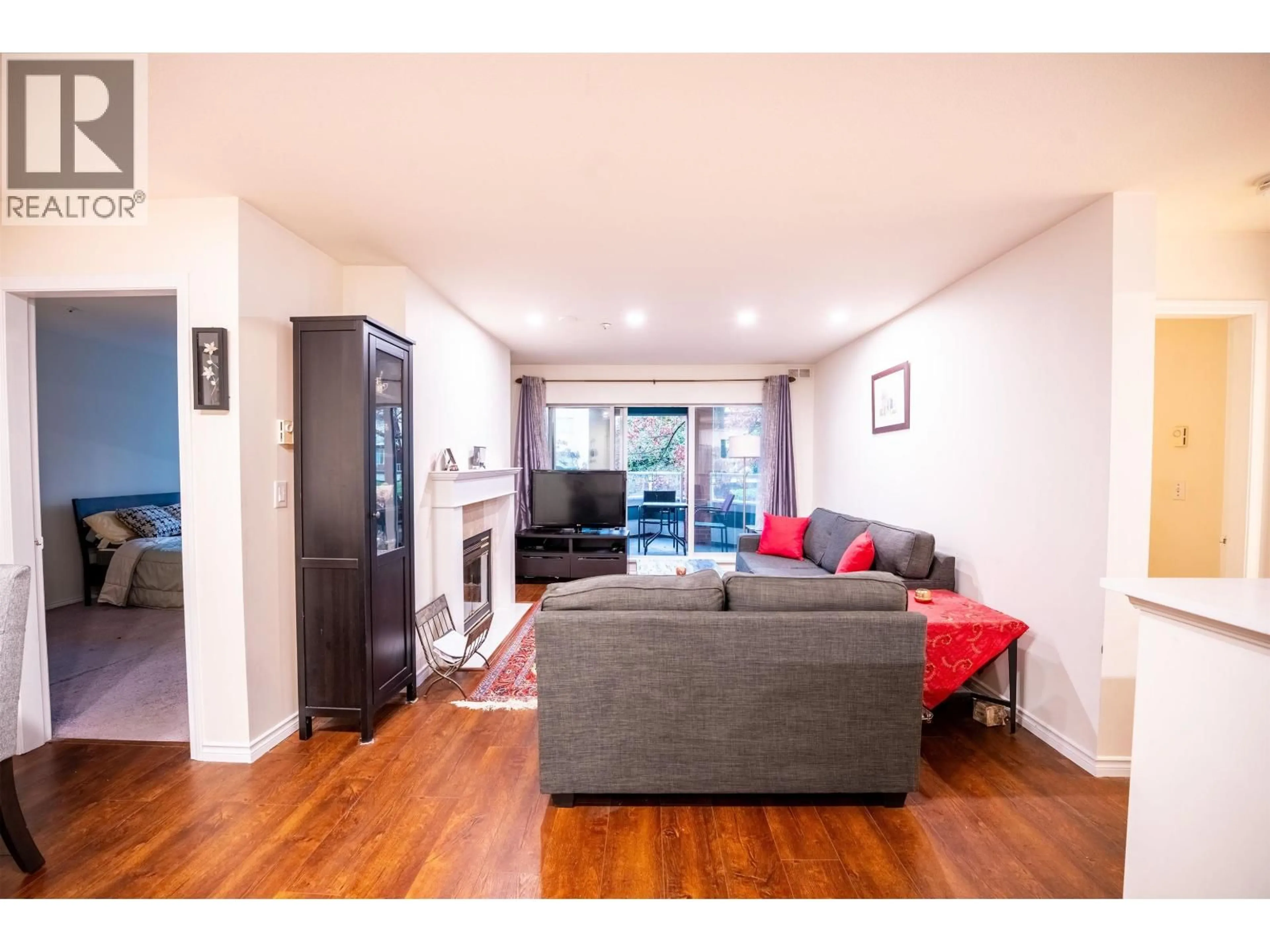 Living room with furniture, wood/laminate floor for 207 - 128 8TH STREET, North Vancouver British Columbia V7M3M1