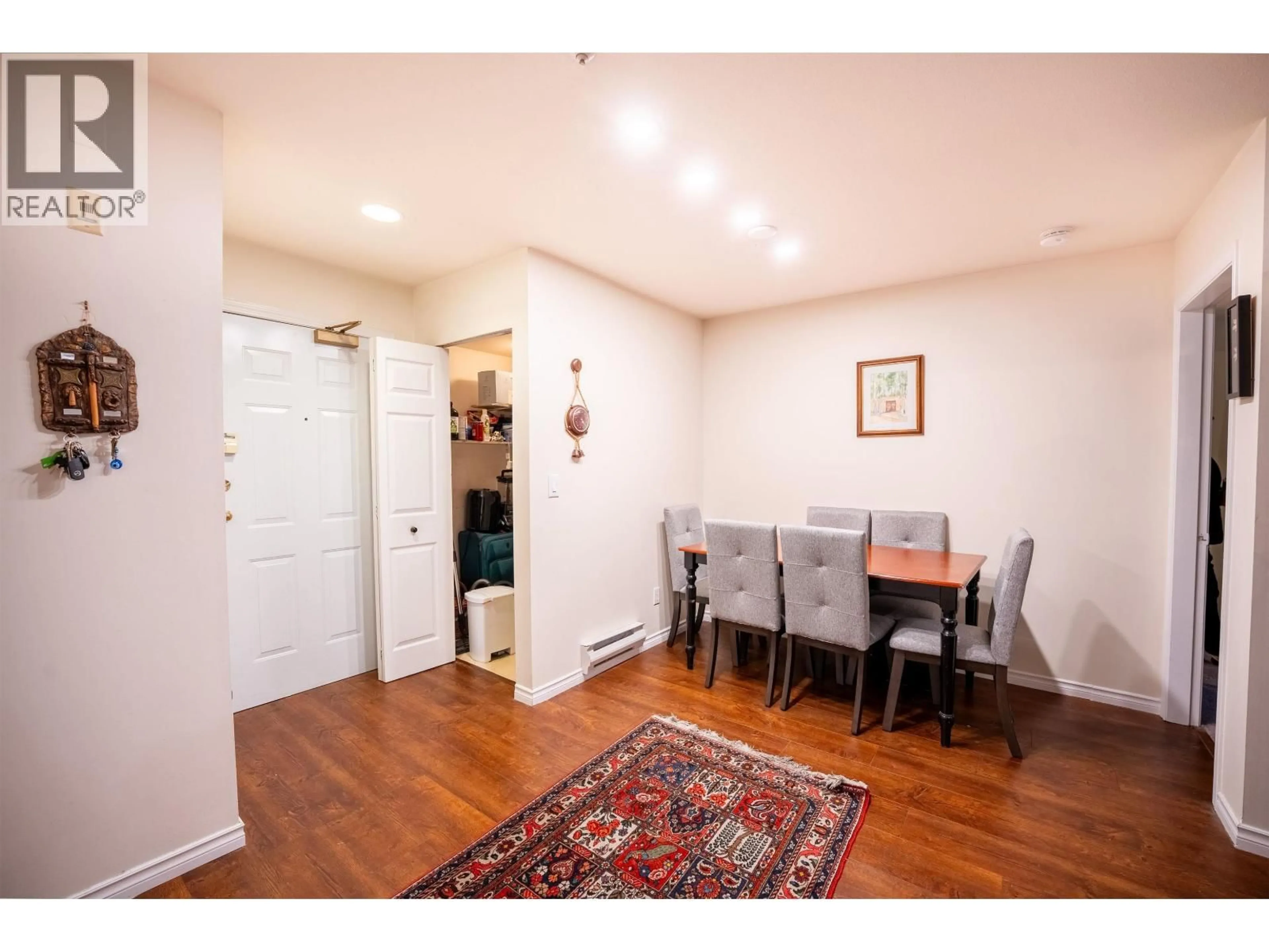 Dining room, wood/laminate floor for 207 - 128 8TH STREET, North Vancouver British Columbia V7M3M1
