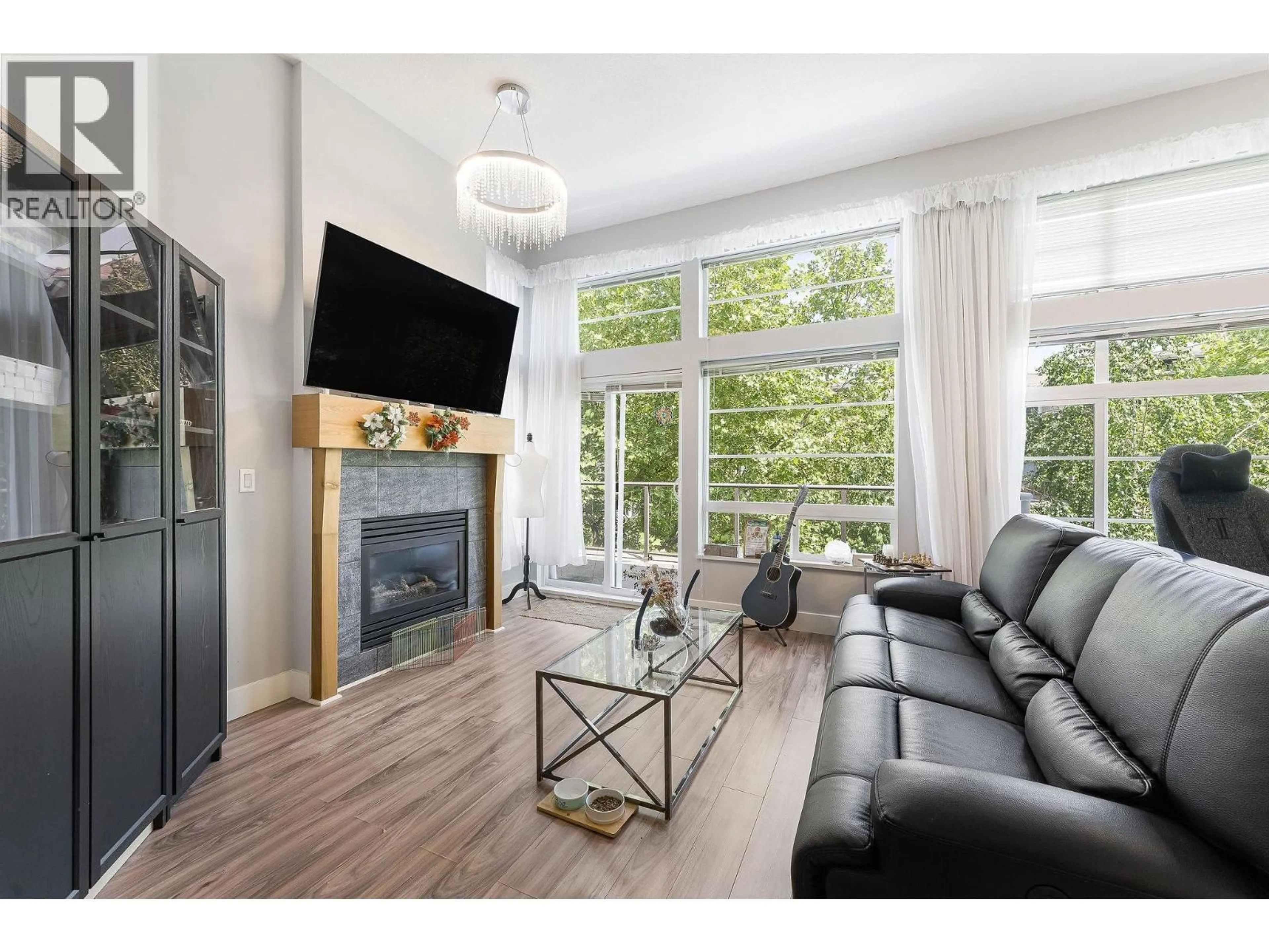 Living room with furniture, wood/laminate floor for 406 - 6328 LARKIN DRIVE, Vancouver British Columbia V6T2K2