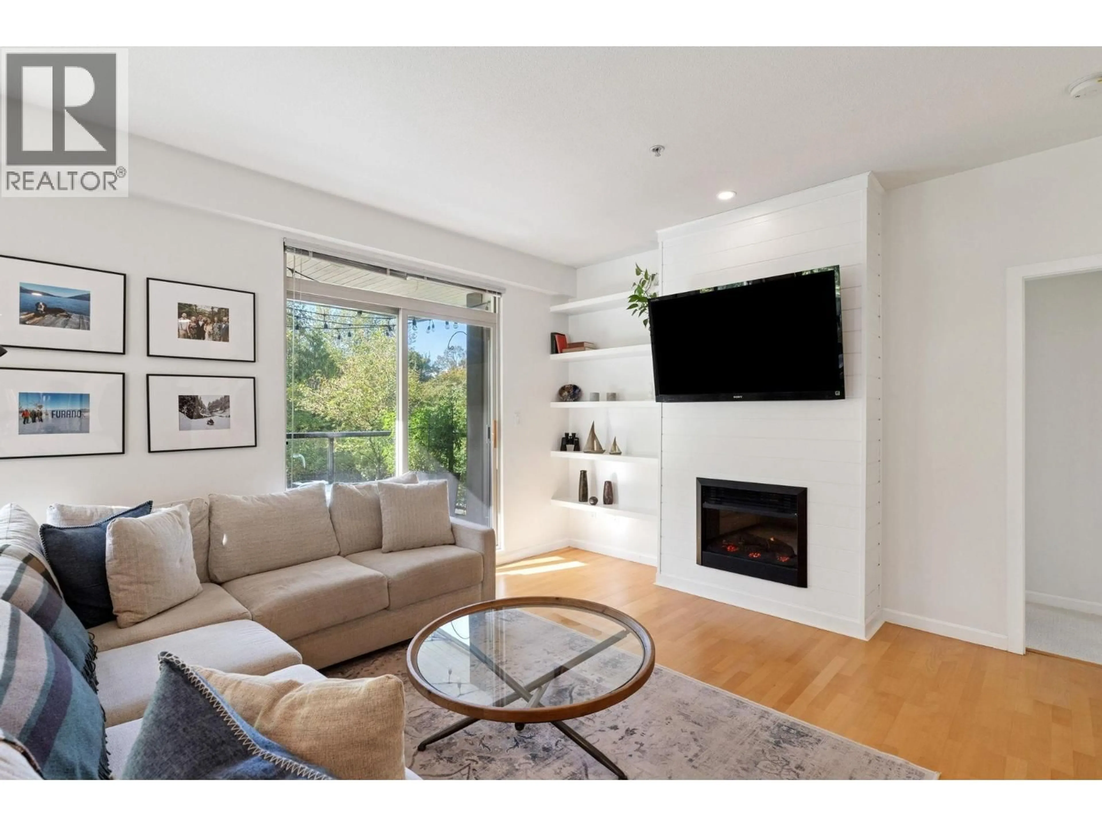 Living room with furniture, wood/laminate floor for 219 - 100 CAPILANO ROAD, Port Moody British Columbia V3H5M9