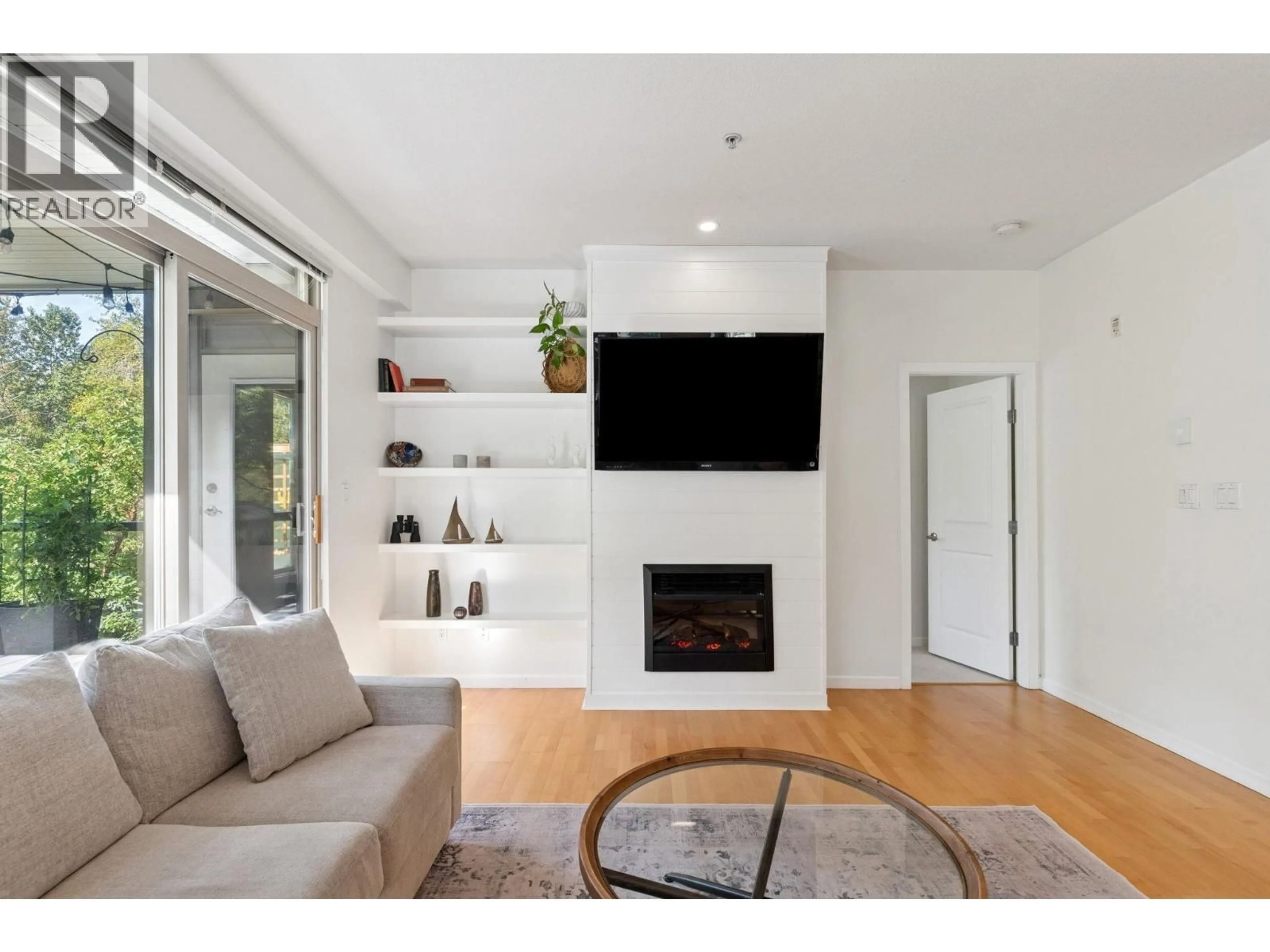 Living room with furniture, wood/laminate floor for 219 - 100 CAPILANO ROAD, Port Moody British Columbia V3H5M9