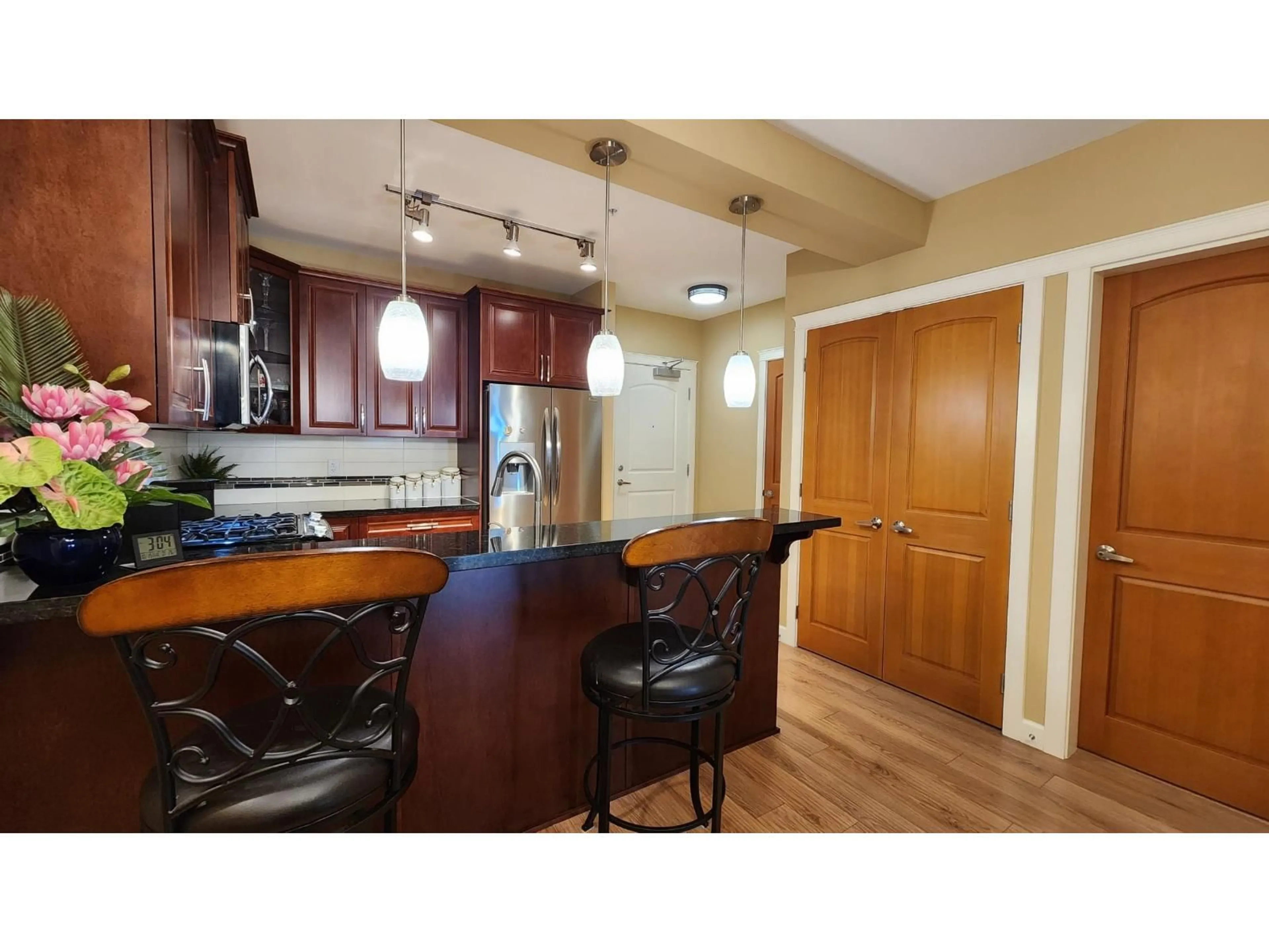 Open concept kitchen, wood/laminate floor for A206 - 8218 207A STREET, Langley British Columbia V2Y0X9