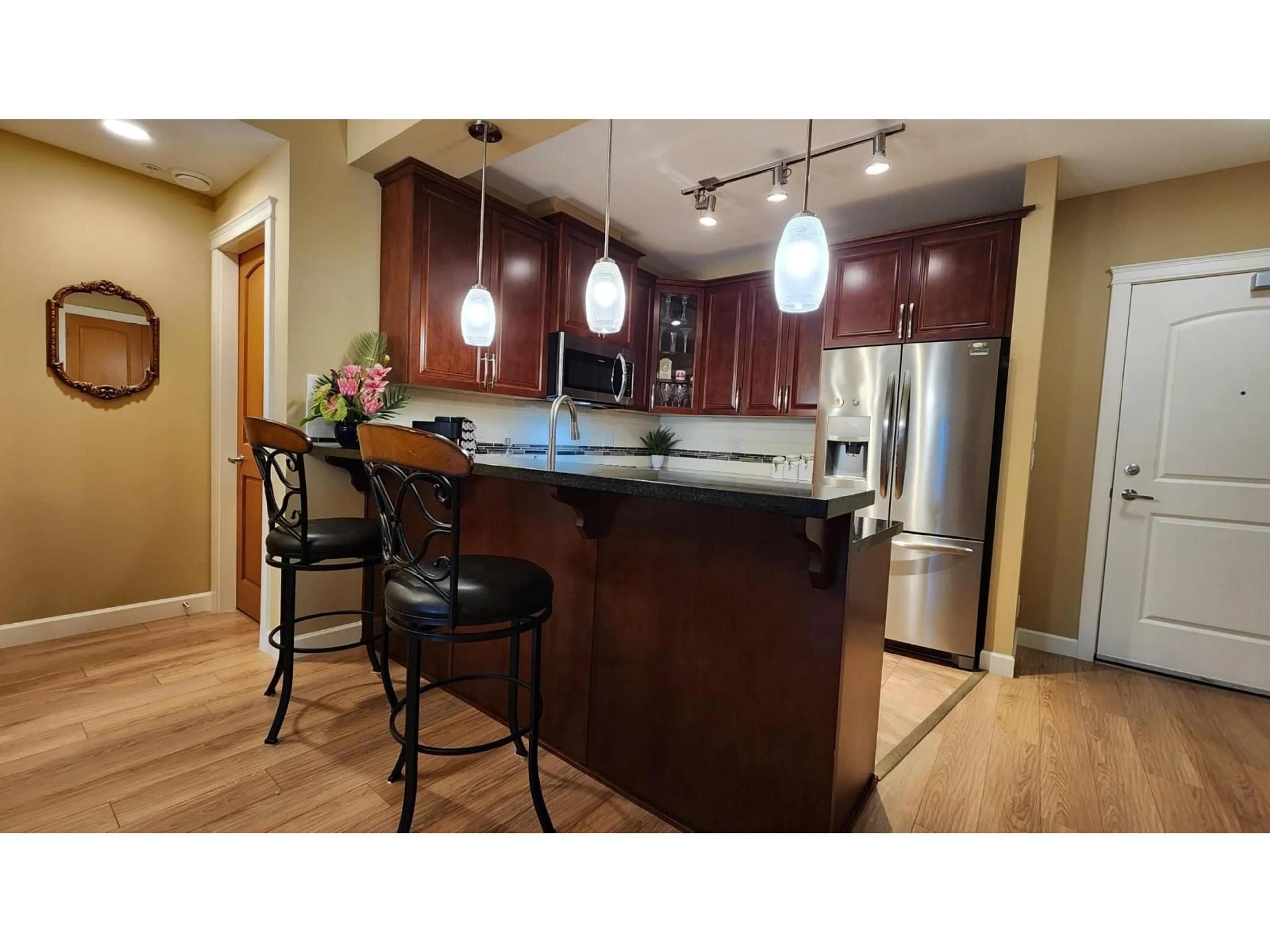Open concept kitchen, wood/laminate floor for A206 - 8218 207A STREET, Langley British Columbia V2Y0X9