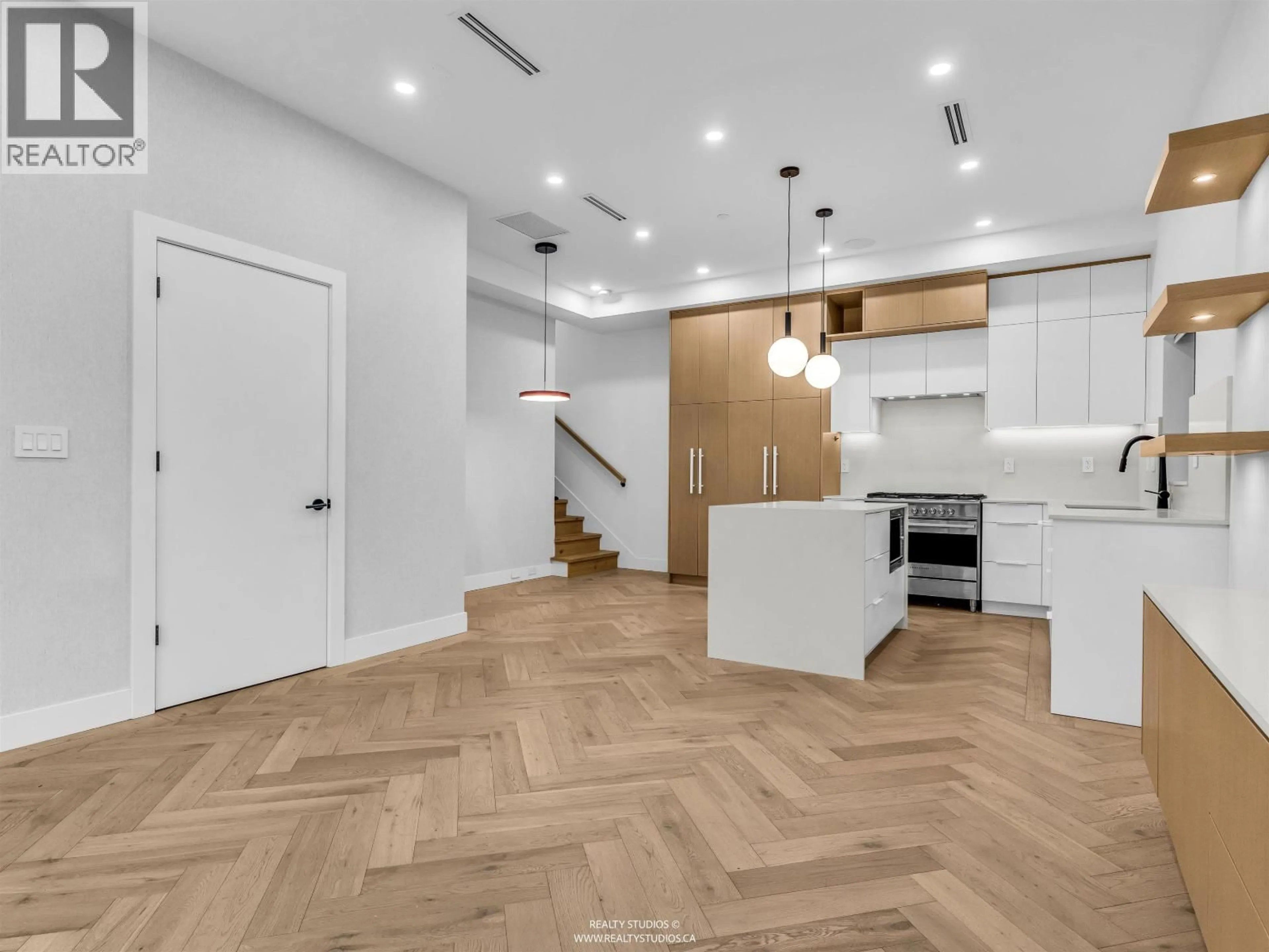 Open concept kitchen, wood/laminate floor for 1 - 3118 WINDSOR STREET, Vancouver British Columbia V5T4B1