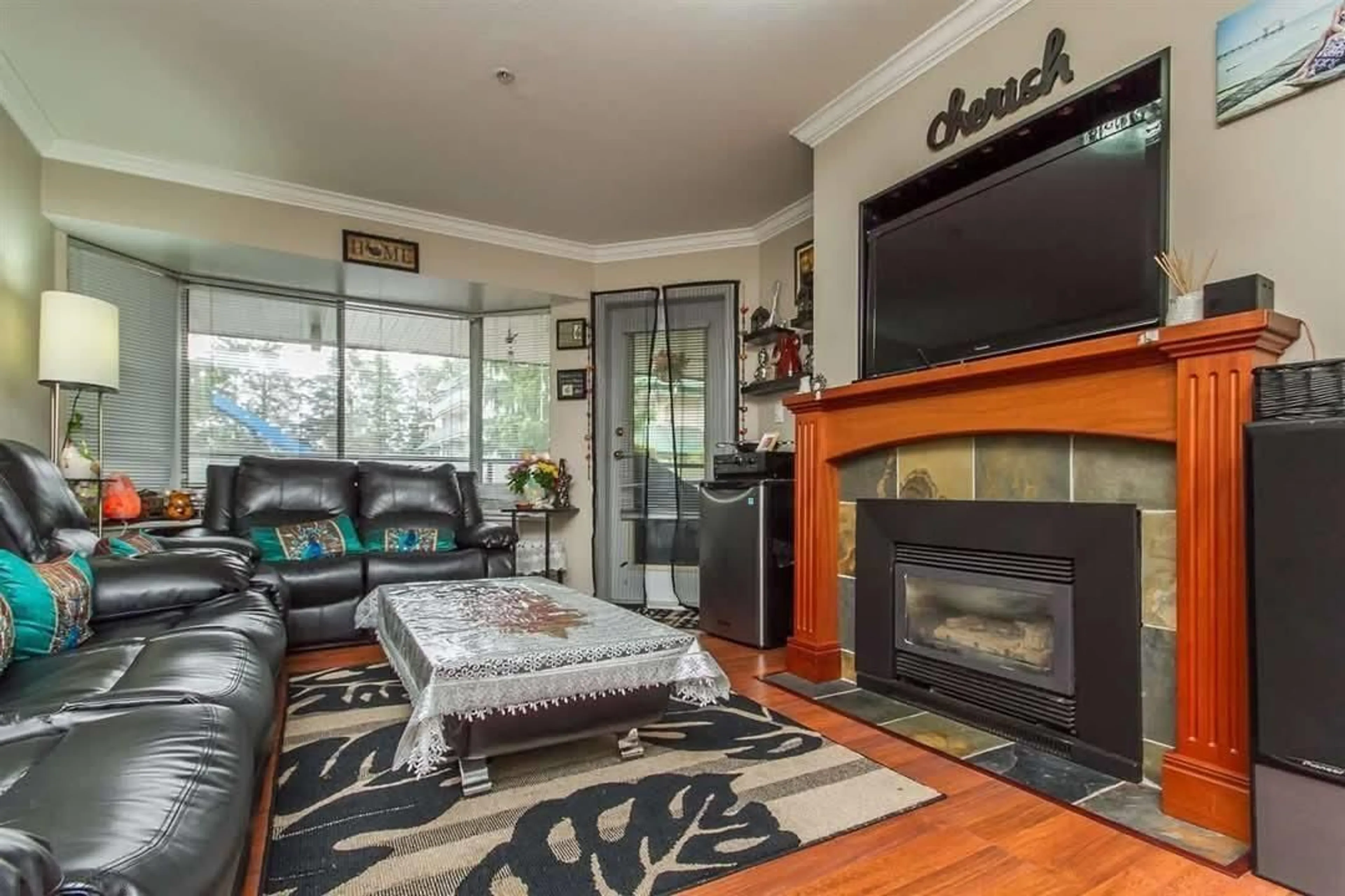 Living room with furniture, wood/laminate floor for 103 2962 TRETHEWEY STREET WEST, Abbotsford British Columbia V2T4M3