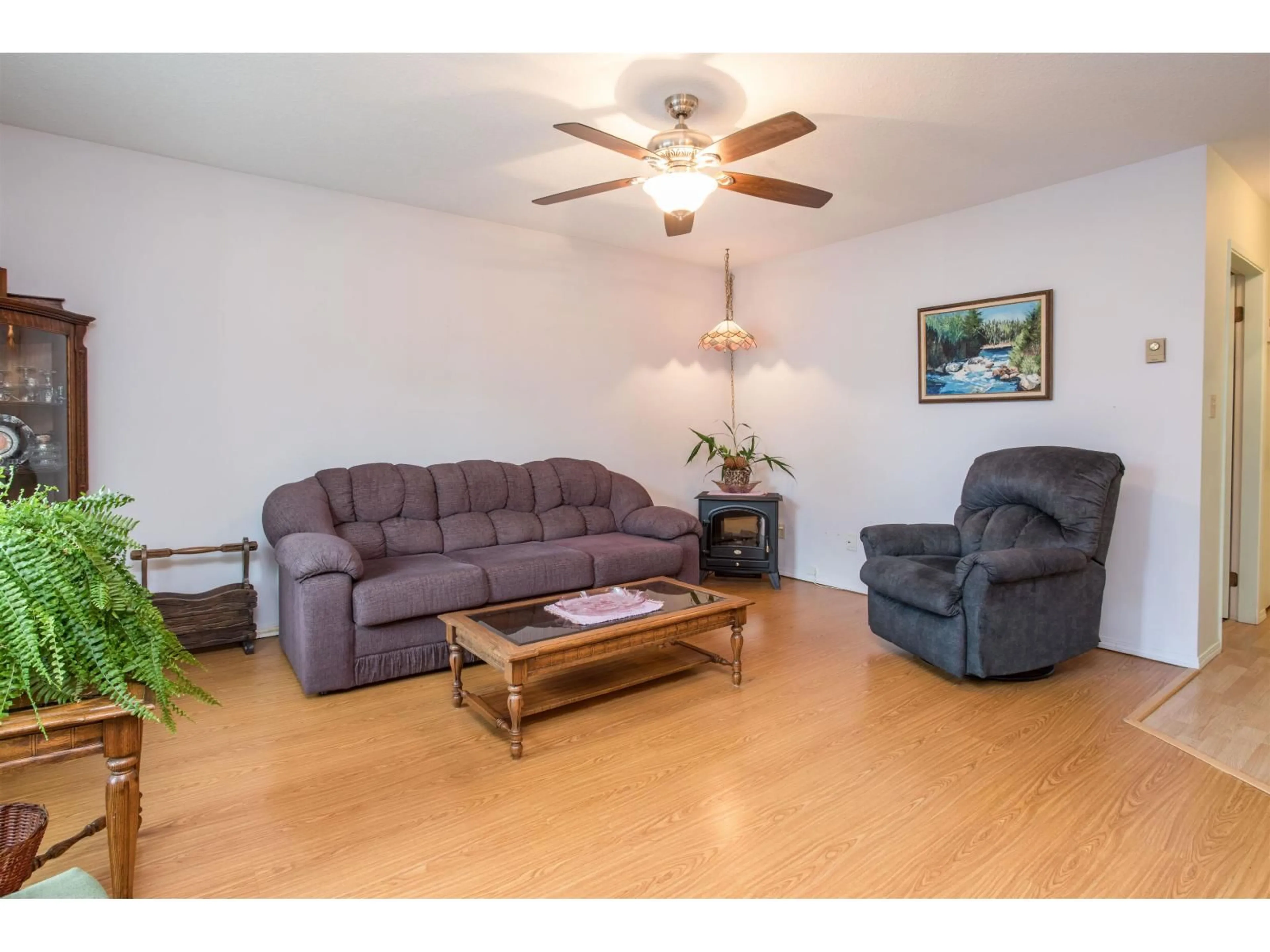 Living room with furniture, wood/laminate floor for 201 - 2853 BOURQUIN CRESCENT, Abbotsford British Columbia V2S6H6