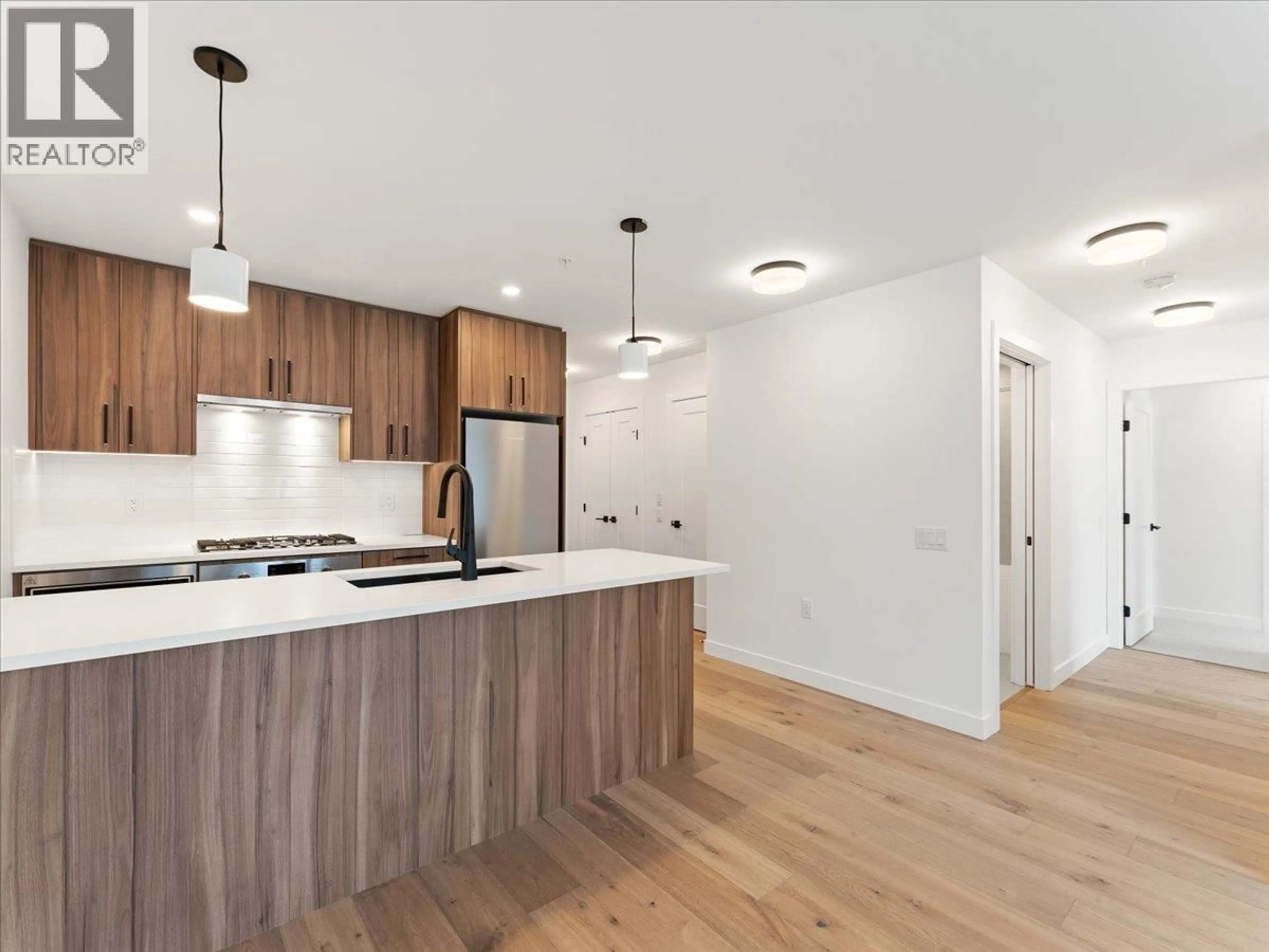Open concept kitchen, wood/laminate floor for 201 - 6859 CAMBIE STREET, Vancouver British Columbia V6P0M4