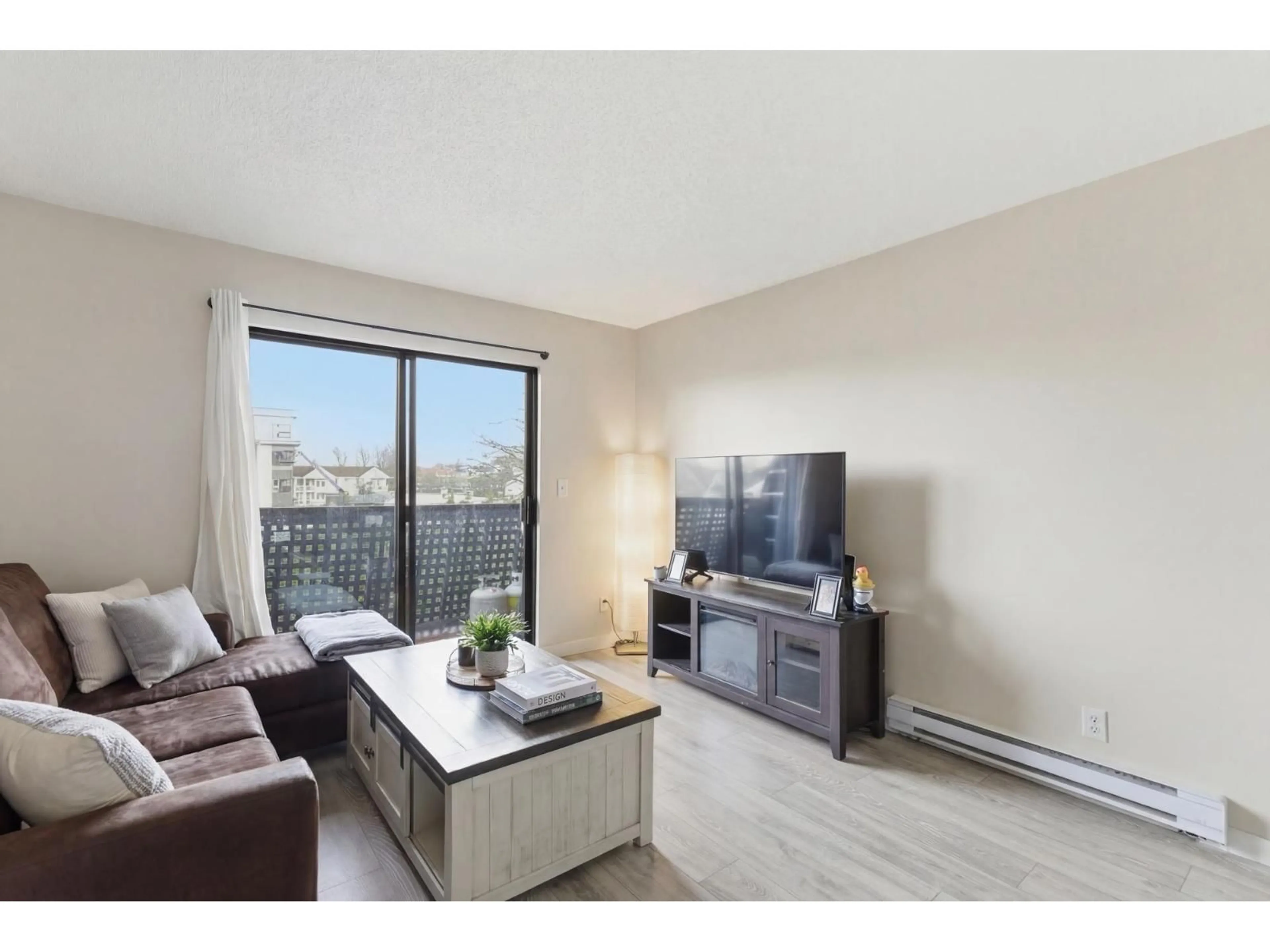 Living room with furniture, wood/laminate floor for 306 - 5906 176A STREET, Surrey British Columbia V3S4H7