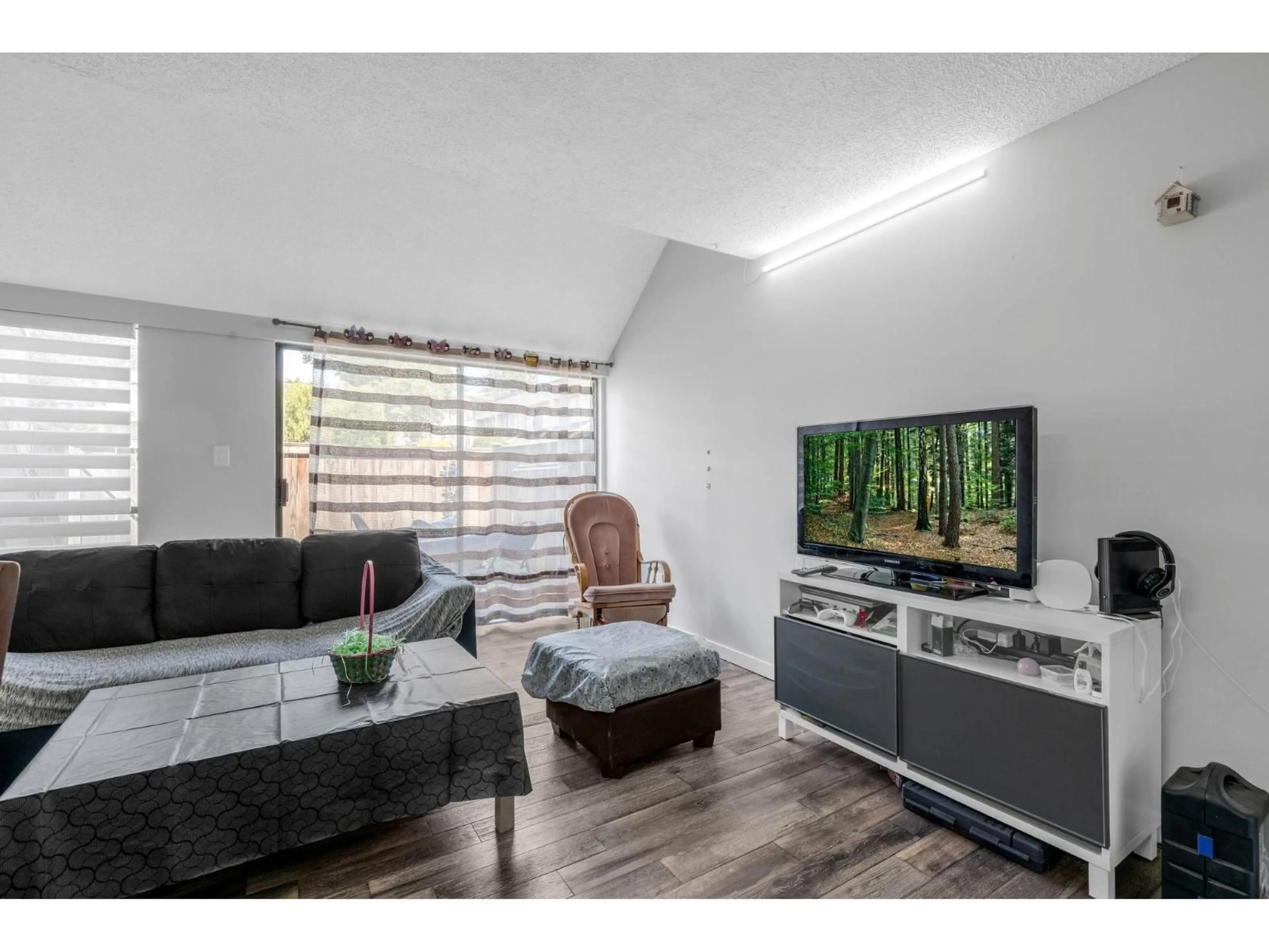 Living room with furniture, wood/laminate floor for 47 - 17708 60 AVENUE, Surrey British Columbia V3S1V2