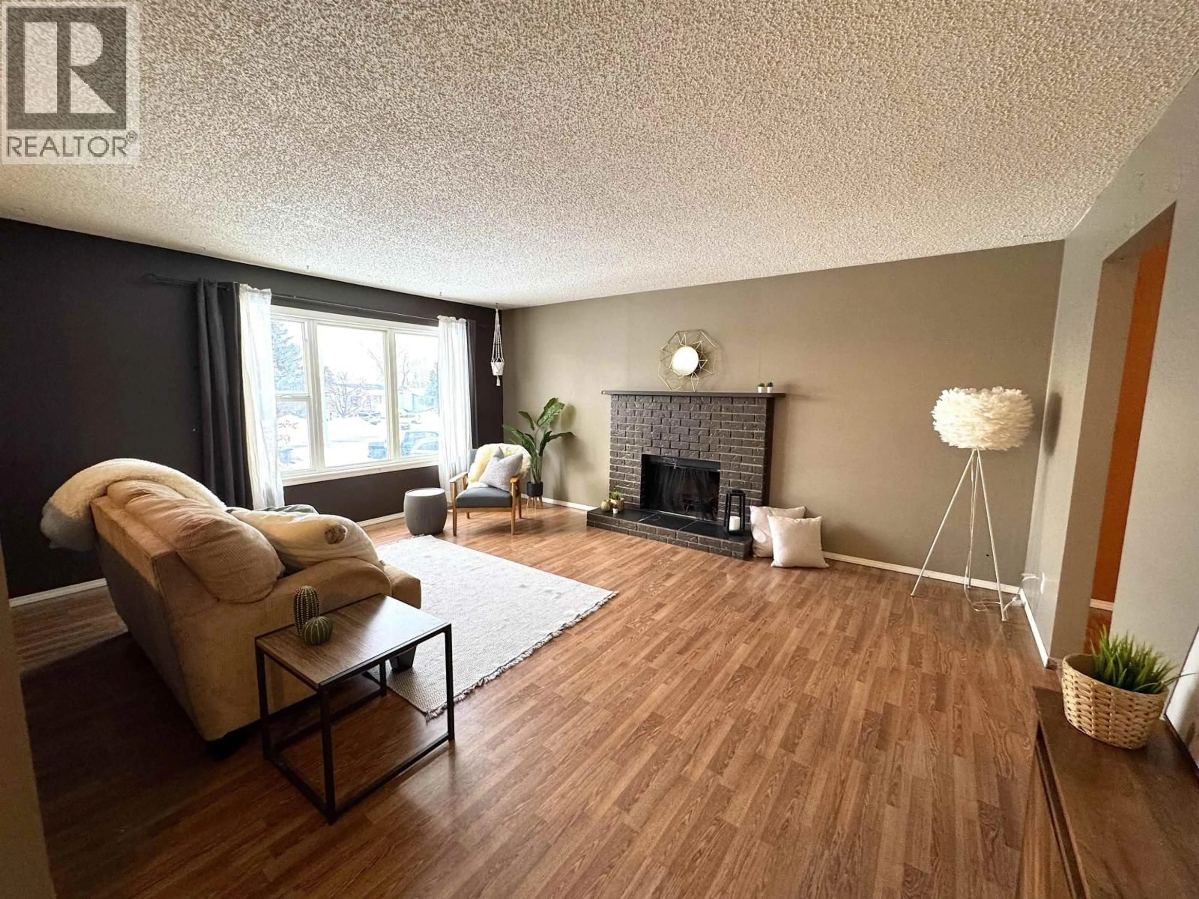 Living room with furniture, wood/laminate floor for 9016 98A AVENUE, Fort St. John British Columbia V1J5E4