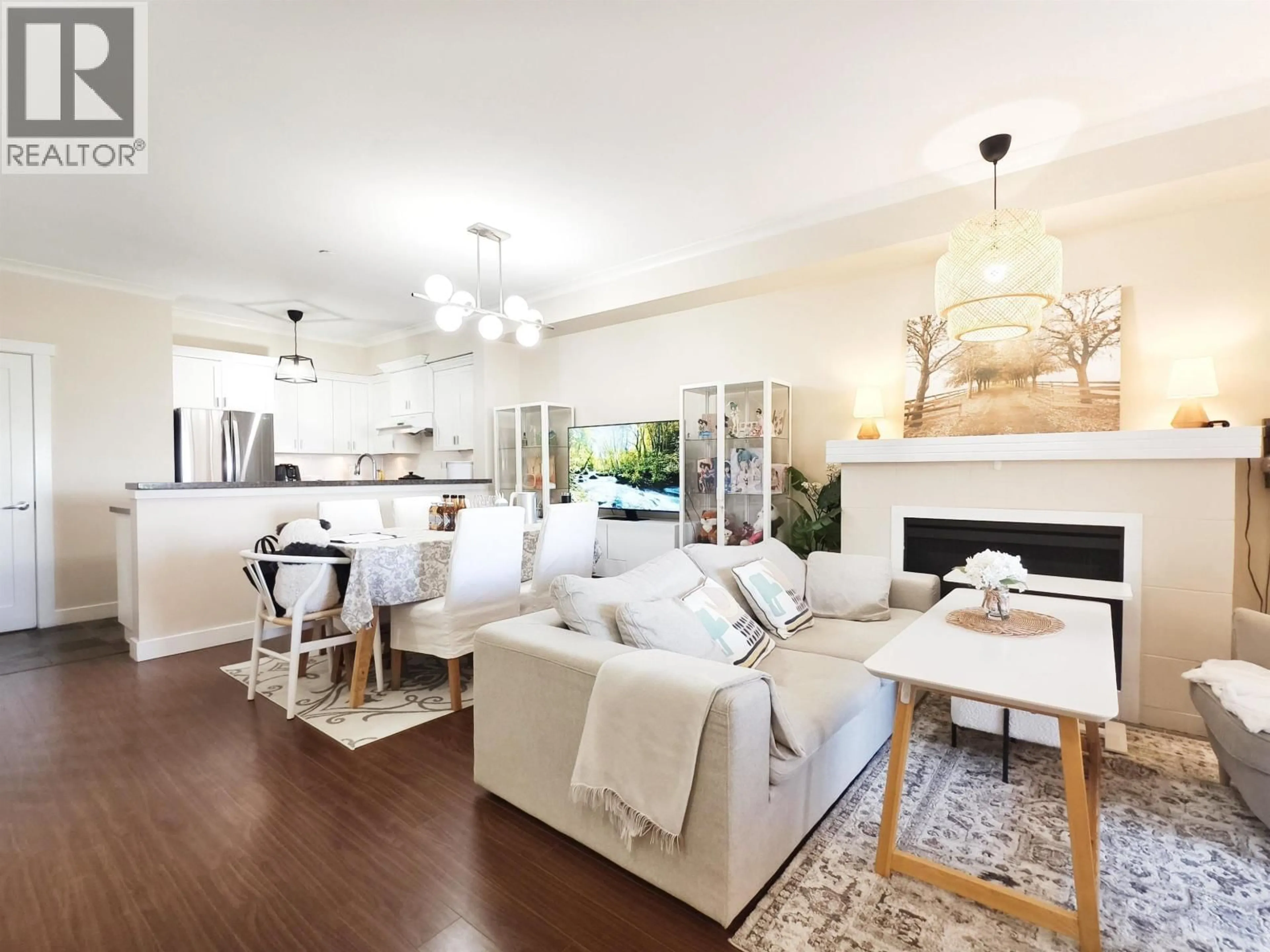 Living room with furniture, wood/laminate floor for 58 - 7388 MACPHERSON AVENUE, Burnaby British Columbia V5J0A1